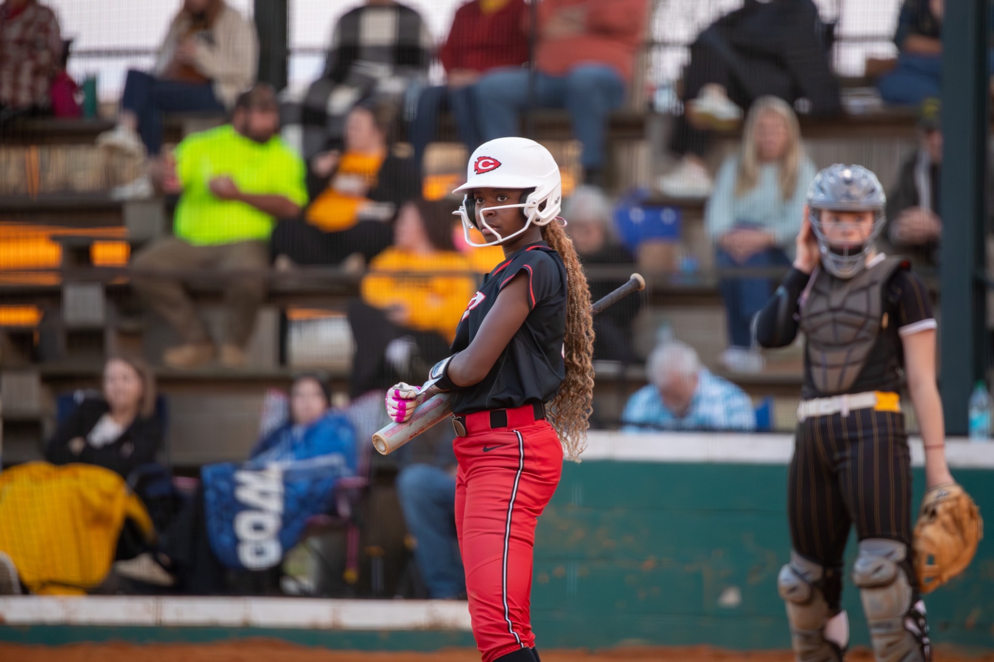 A Lady Arrow looks to the third-base coach for a signal.