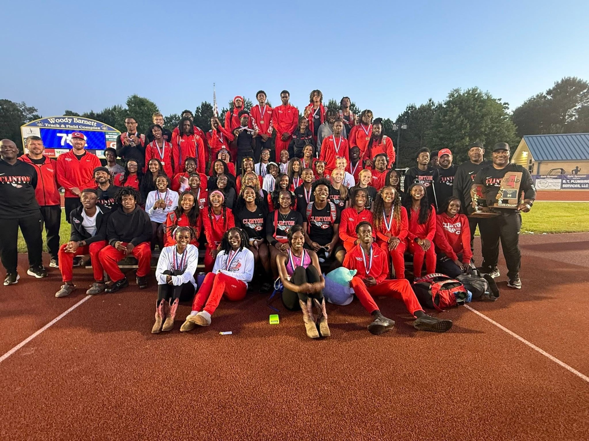 The Clinton High School Track and Field team celebrates their state titles on Saturday, May 2, in Pearl.