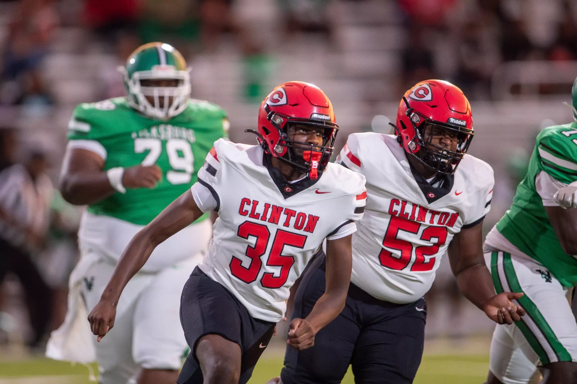 Arrow Football players 35 and 52 run around Vicksburg's offense.