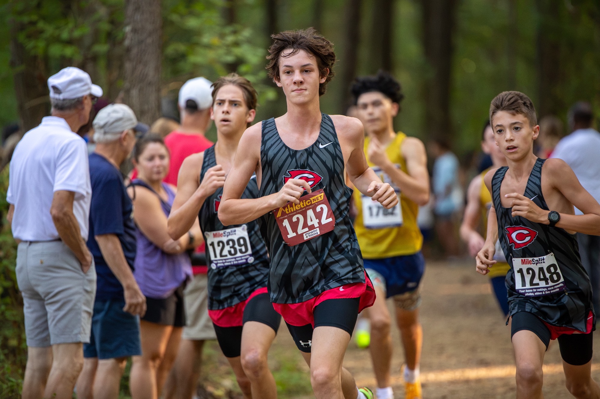 Three Clinton Varsity Cross Country athletes run the trail in Brandon, MS.