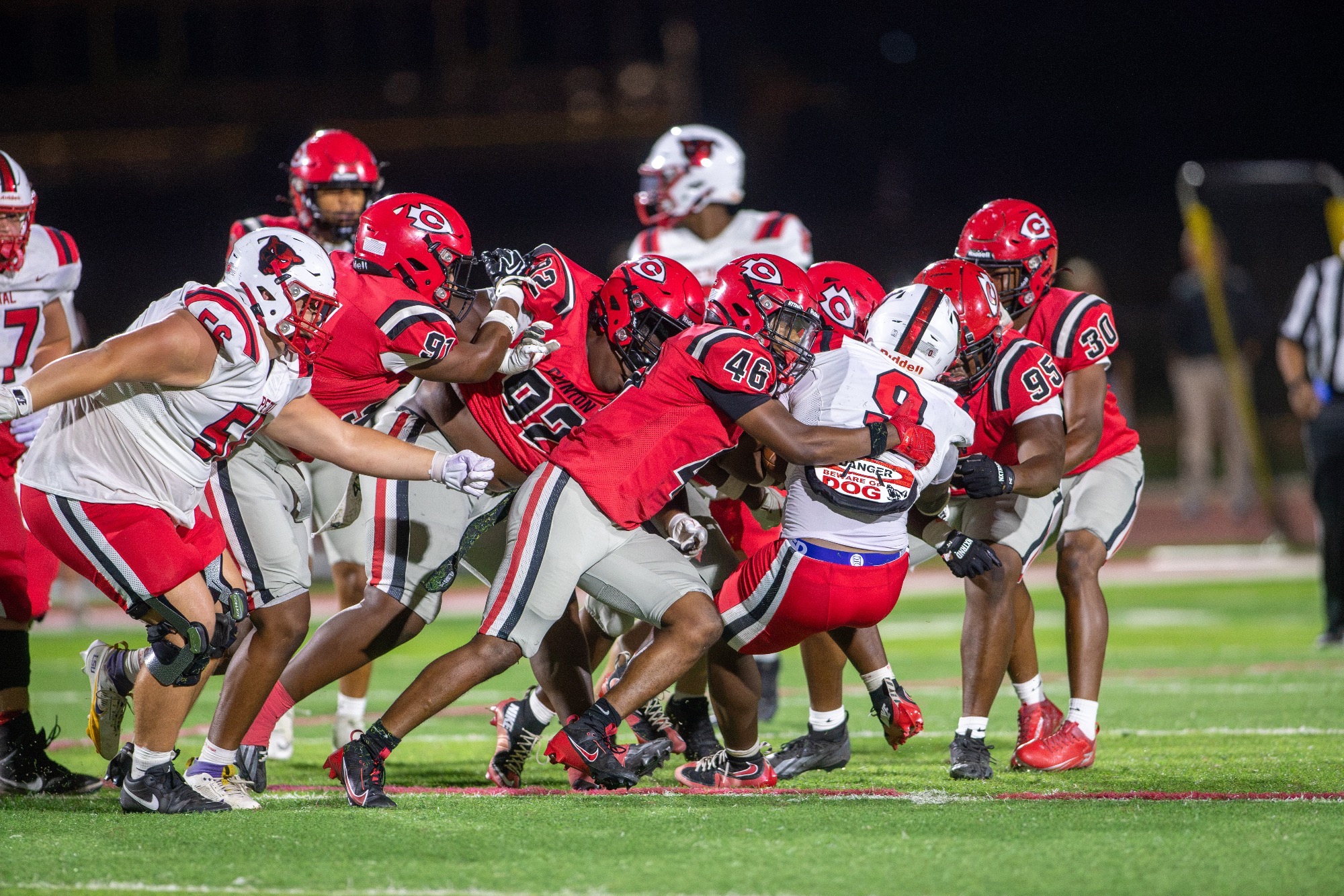 Montario Braden leads a horde of Clinton Arrow defenders in a tackle against Petal on Sept. 25, at Arrow Field.