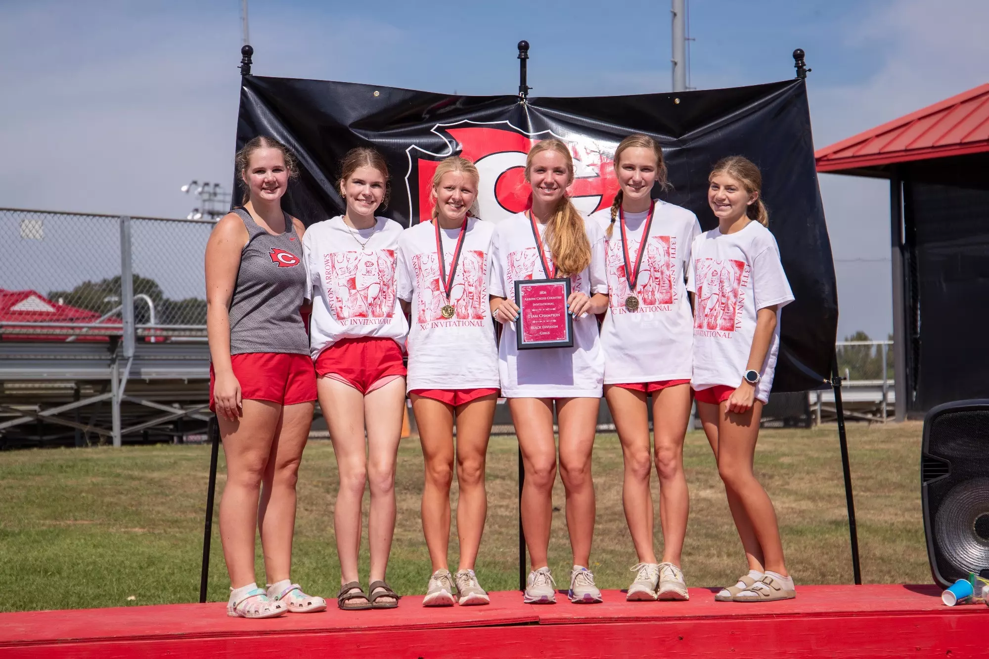 The Clinton High School women's cross country team celebrate their championship at the Clinton Arrow Invitational on Saturday, Sept. 26, on the campus of Clinton High School.