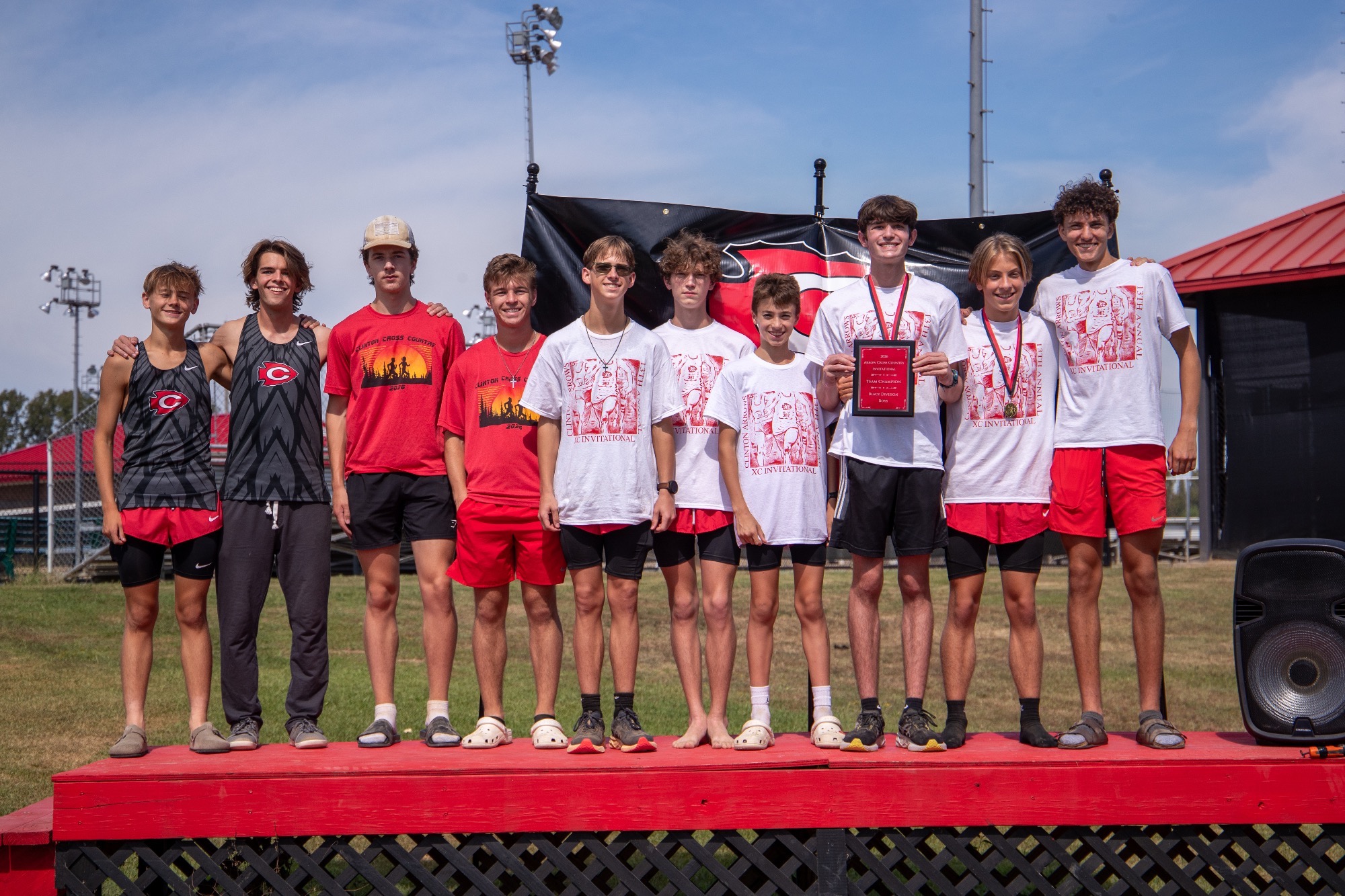 The Clinton High School men's cross country team celebrates a team championship at the Clinton Arrow Invitational on Saturday, Sept. 26, on the campus of Clinton High School.