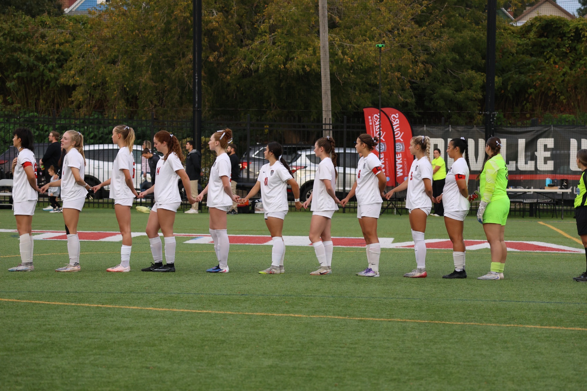 D'Youville Women's Soccer hold Hands During the National Antem 