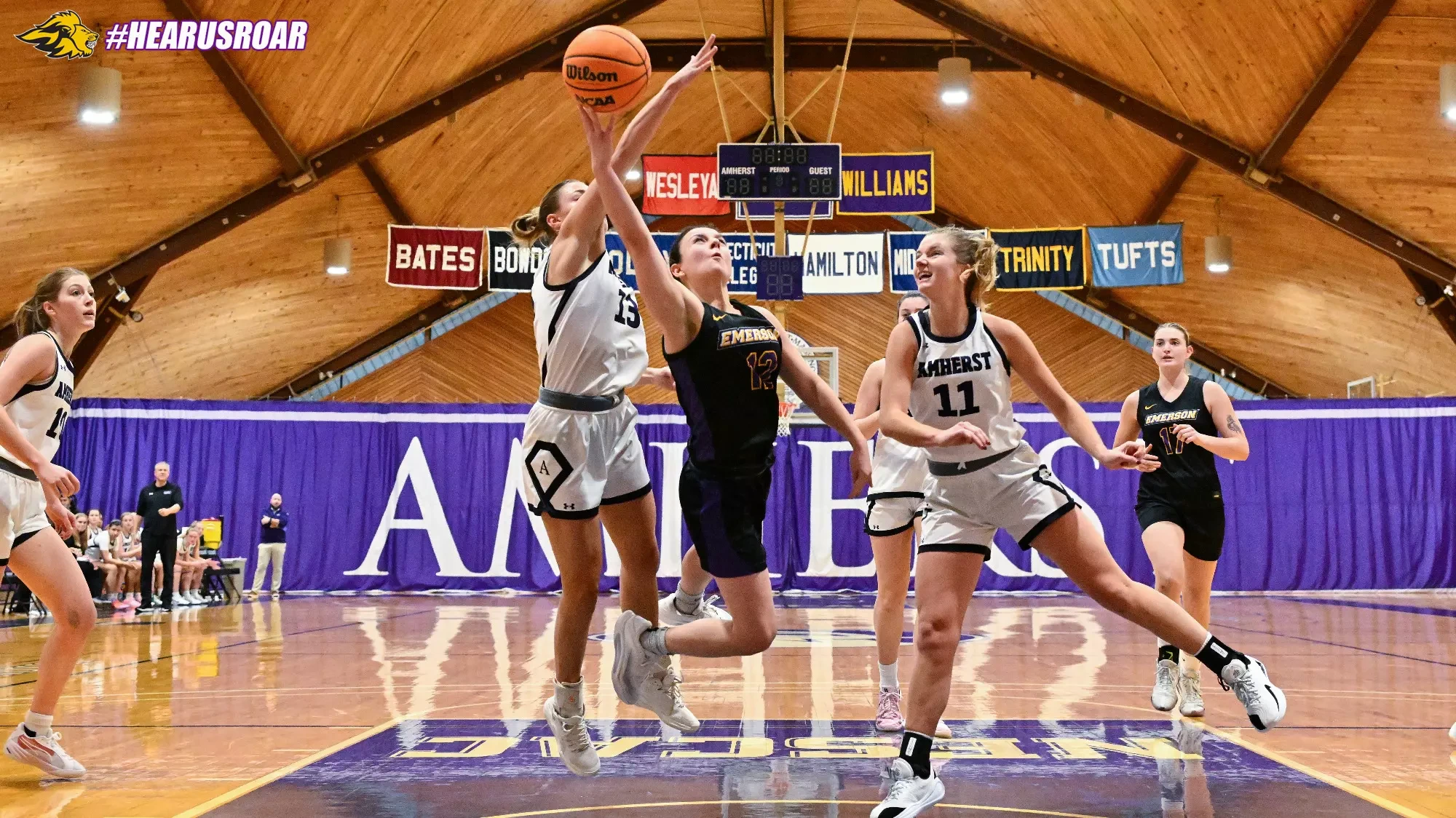 Bri Frongillo drives the lane for a contested basket at Amherst