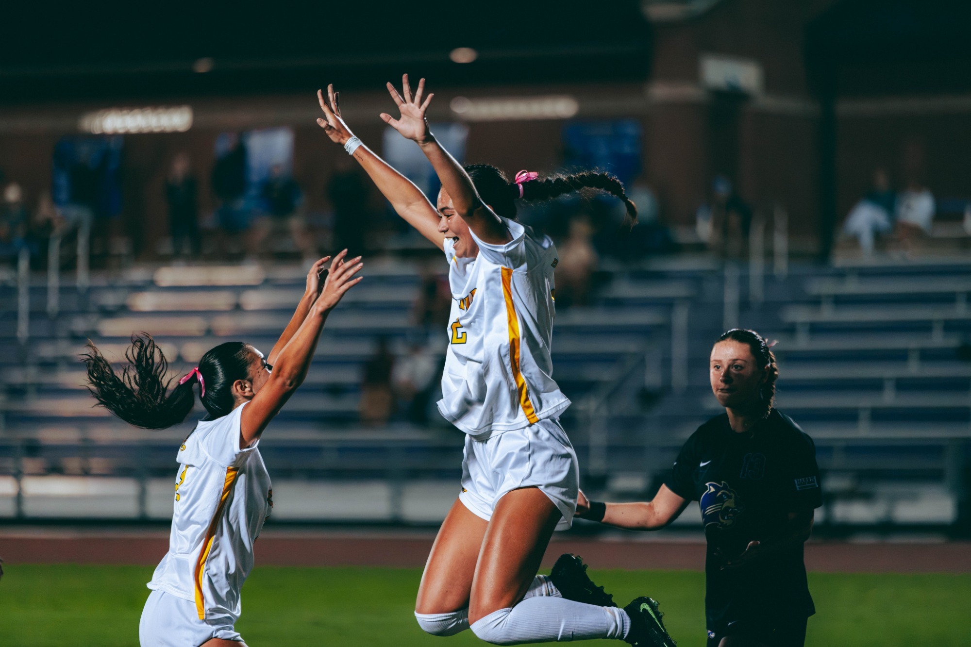 Alex Beck leaps in the air to celebrate a goal during a soccer match at Western Carolina.
