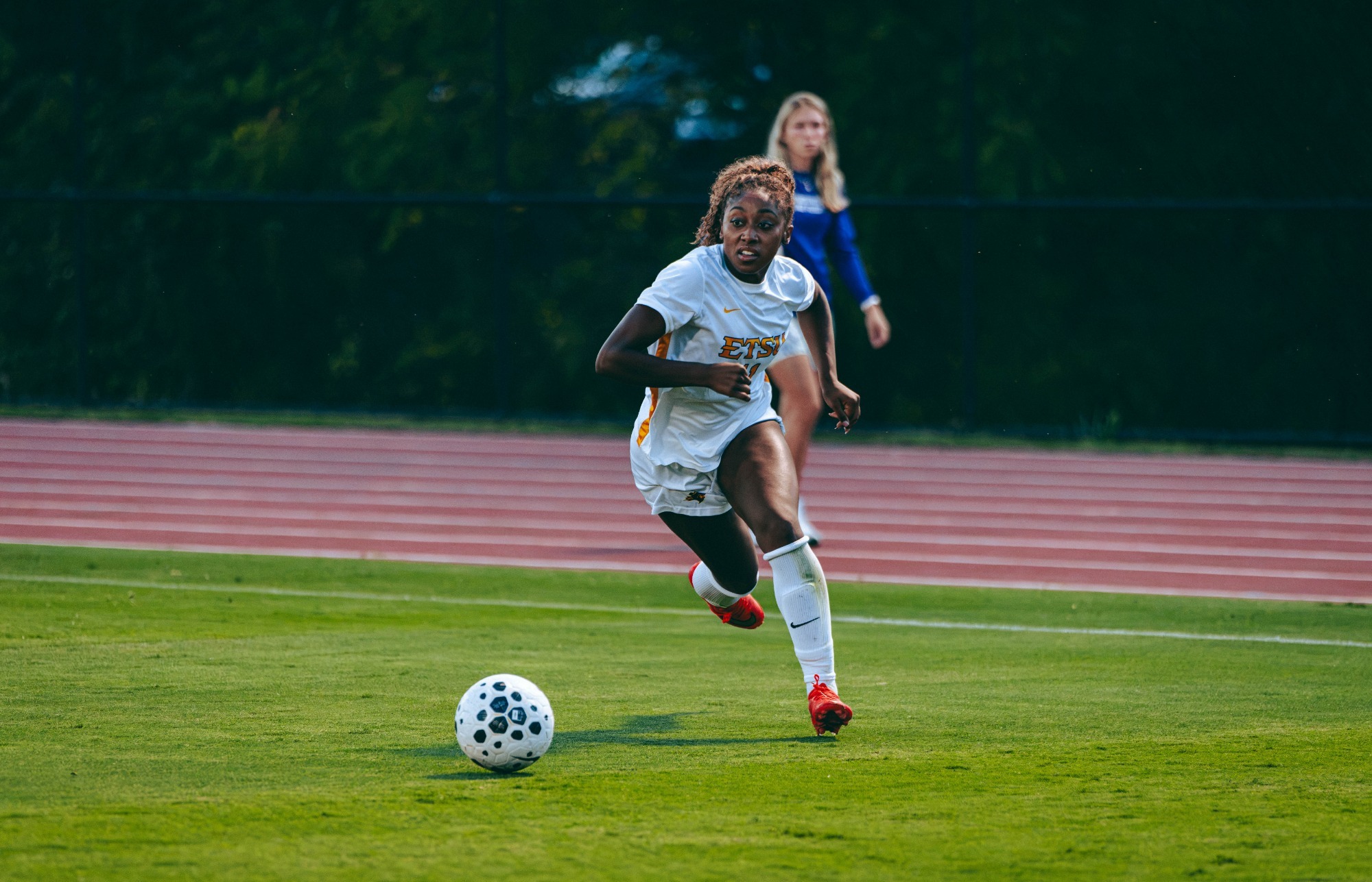 Jada Cooper lines up a long pass from along the sideline during an evening soccer game against Western Carolina.