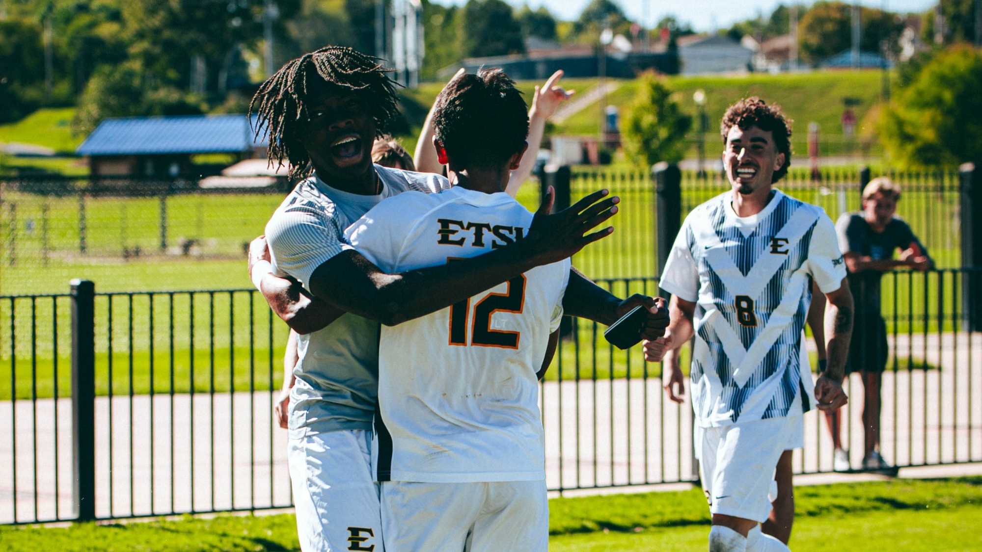 Micah Kwende celebrates a goal with Joe Gonzalez during a soccer match against VMI.