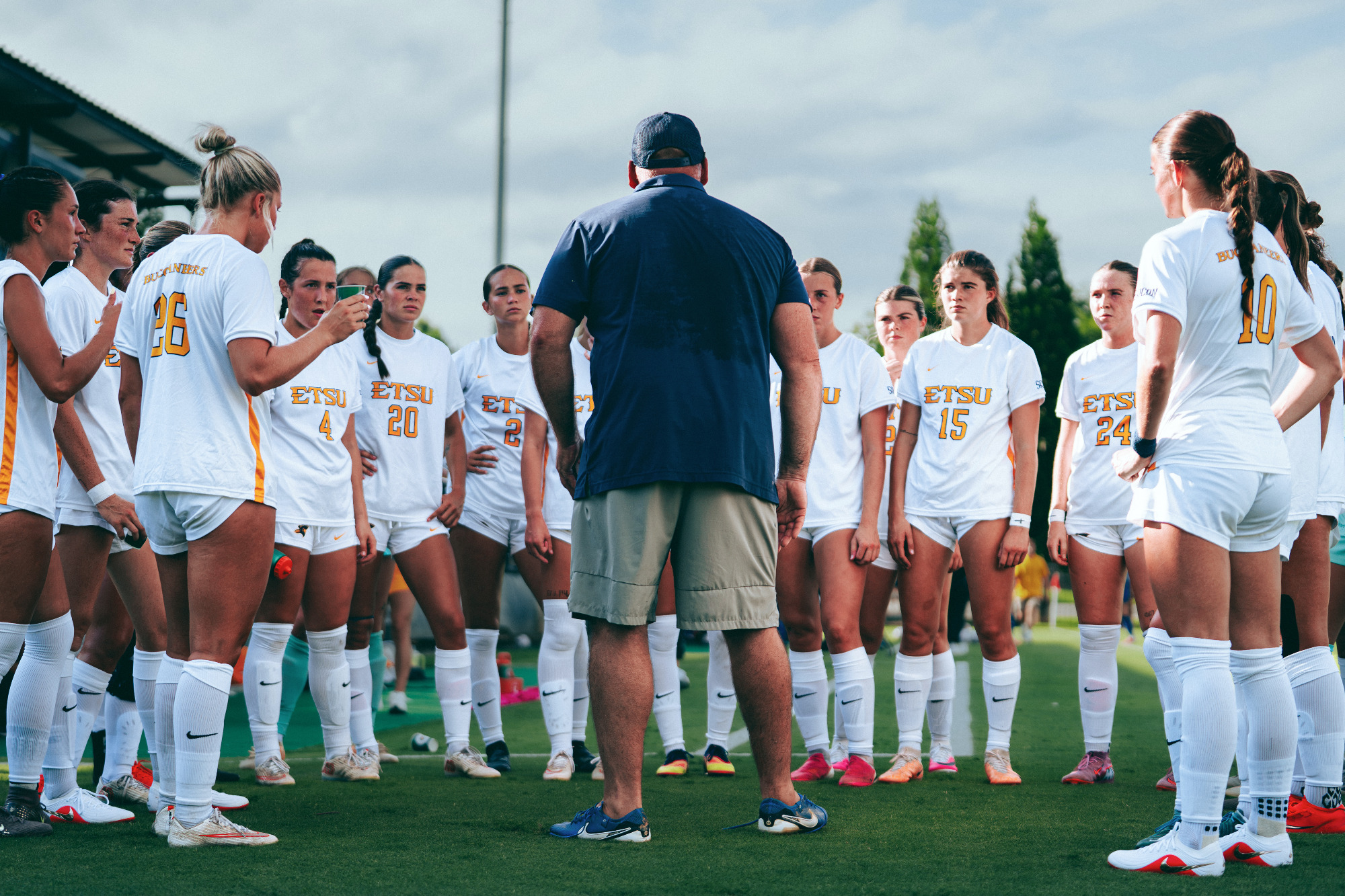Jay Yelton gives his team their final instructions in the huddle before a soccer match.