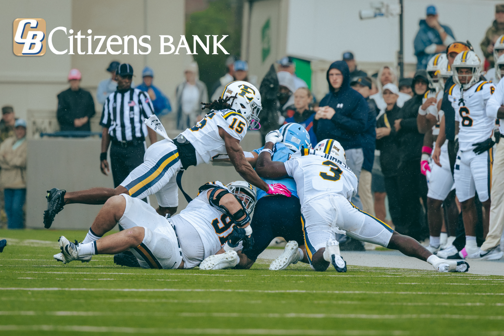A few ETSU defenders combine for a tackle in a game against The Citadel