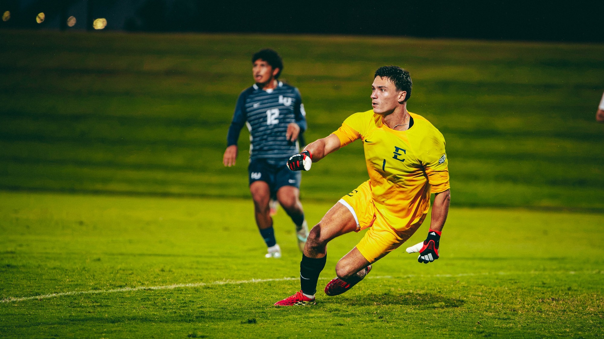 Noé Delmotte slides across the face of his goal to defend an incoming shot during a soccer match against Liberty.