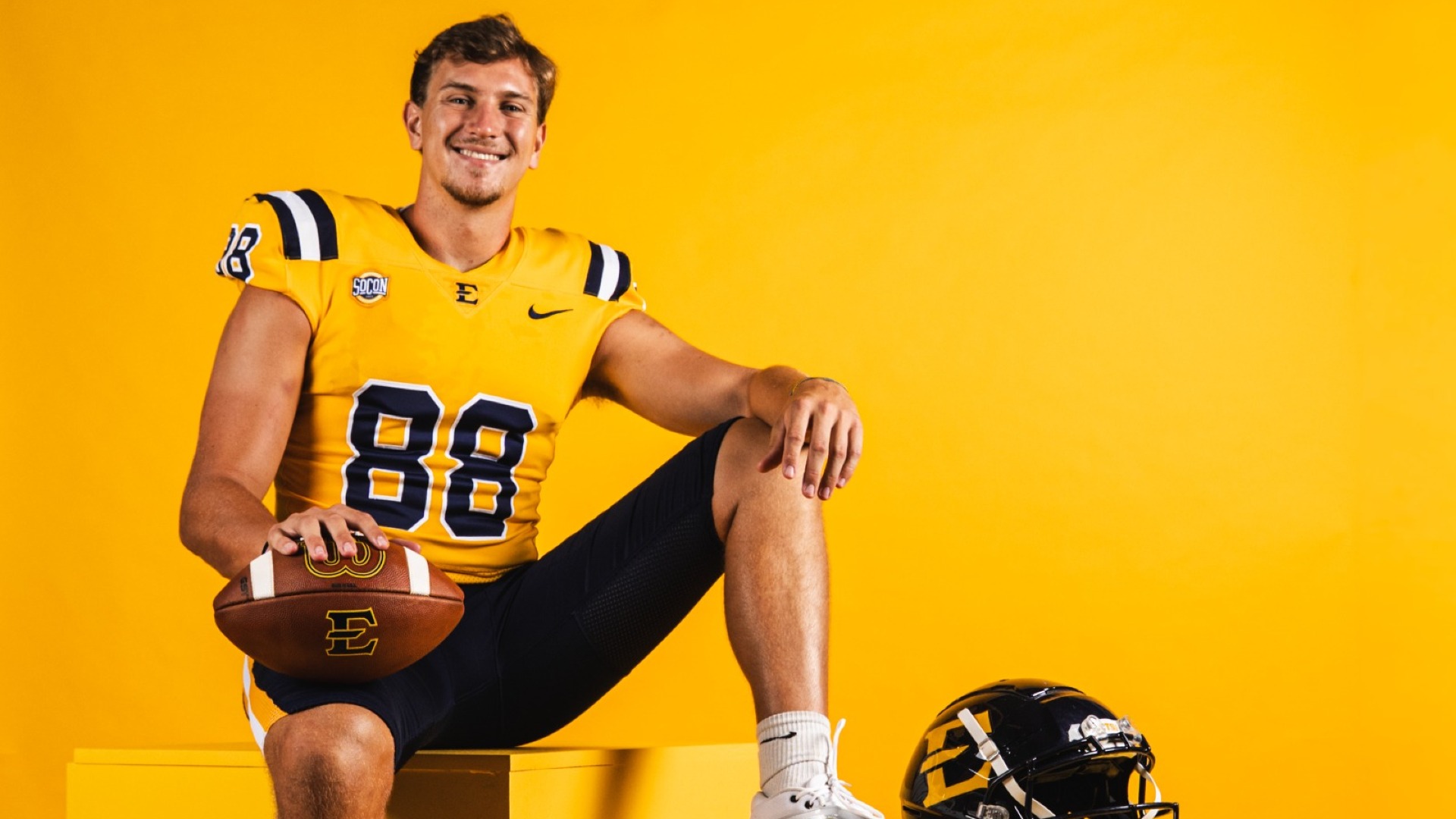 Browder sitting posed with helmet and football