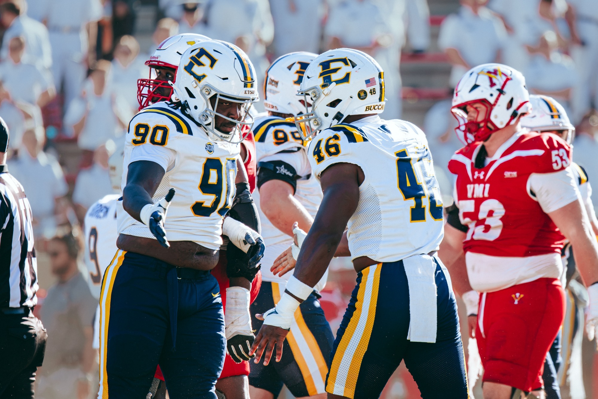 A pair of Buccaneer defenders congratulate each other after a good play against VMI