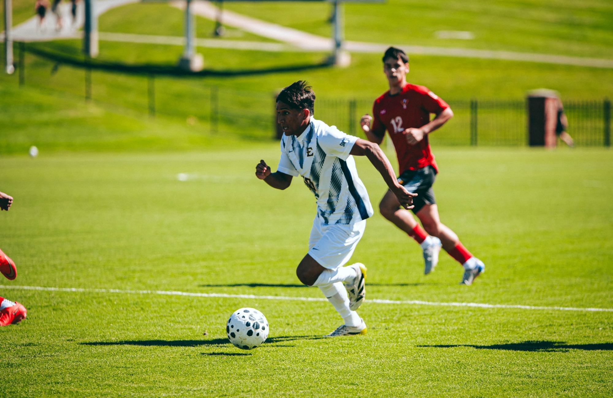 Jaime Carrillo dribbles toward a defender outside the frame during a soccer match against VMI.