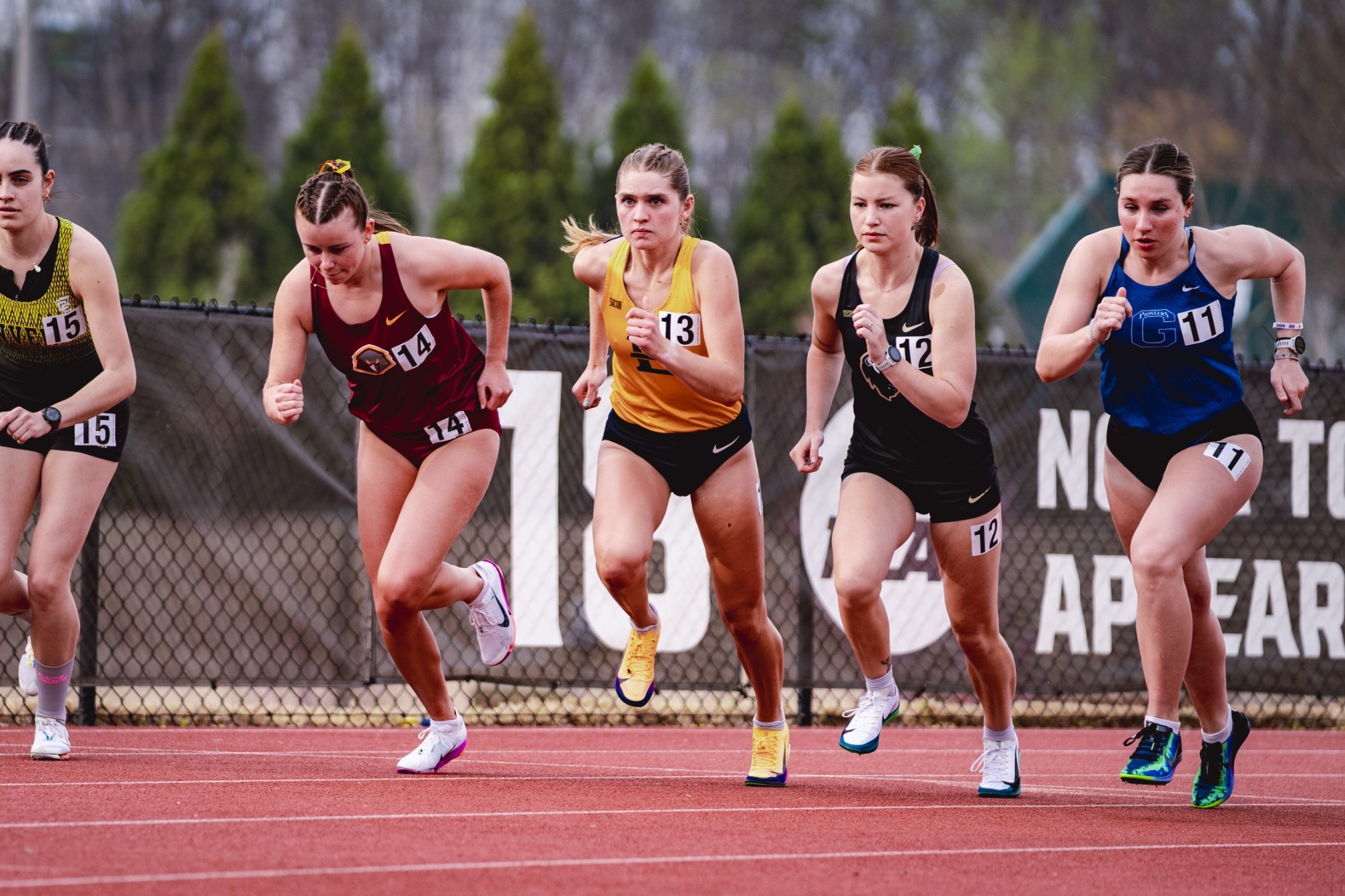 Deena Ludtke races through the middle of a crowded pack of distance runners