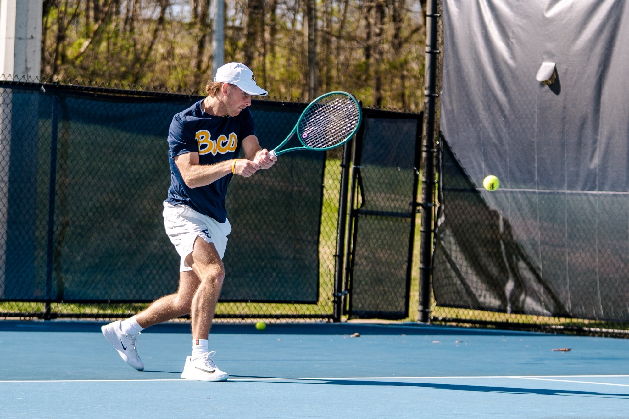 James Sim returns a ball in a match against Mercer