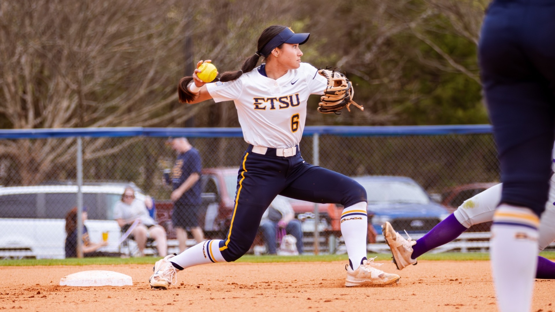 Softball's Tiare Rieger fielding and throwing a ball during the Western Carolina series