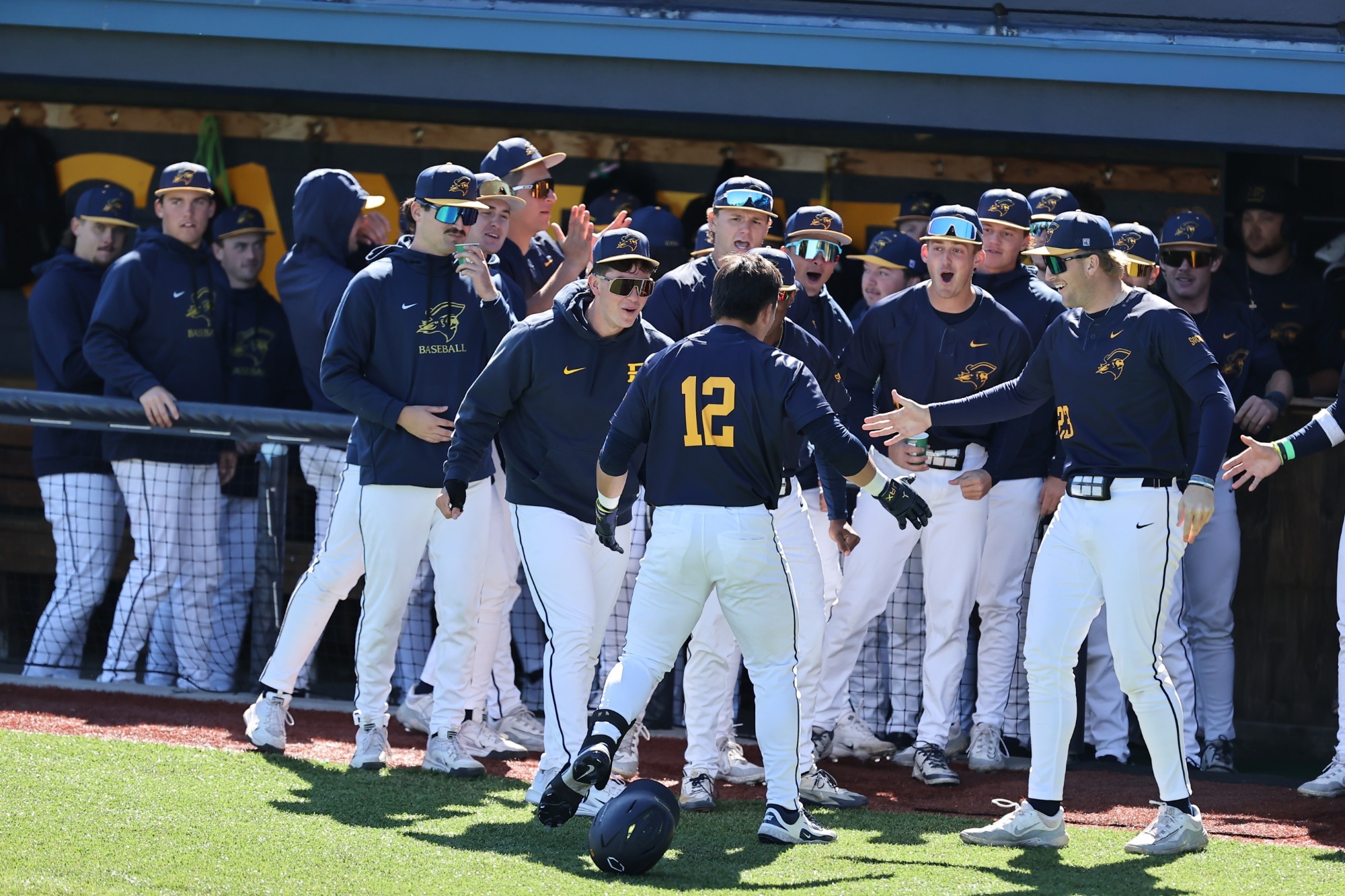 The ETSU baseball team celebrates after Ian Guanzon hits a home run against VMI