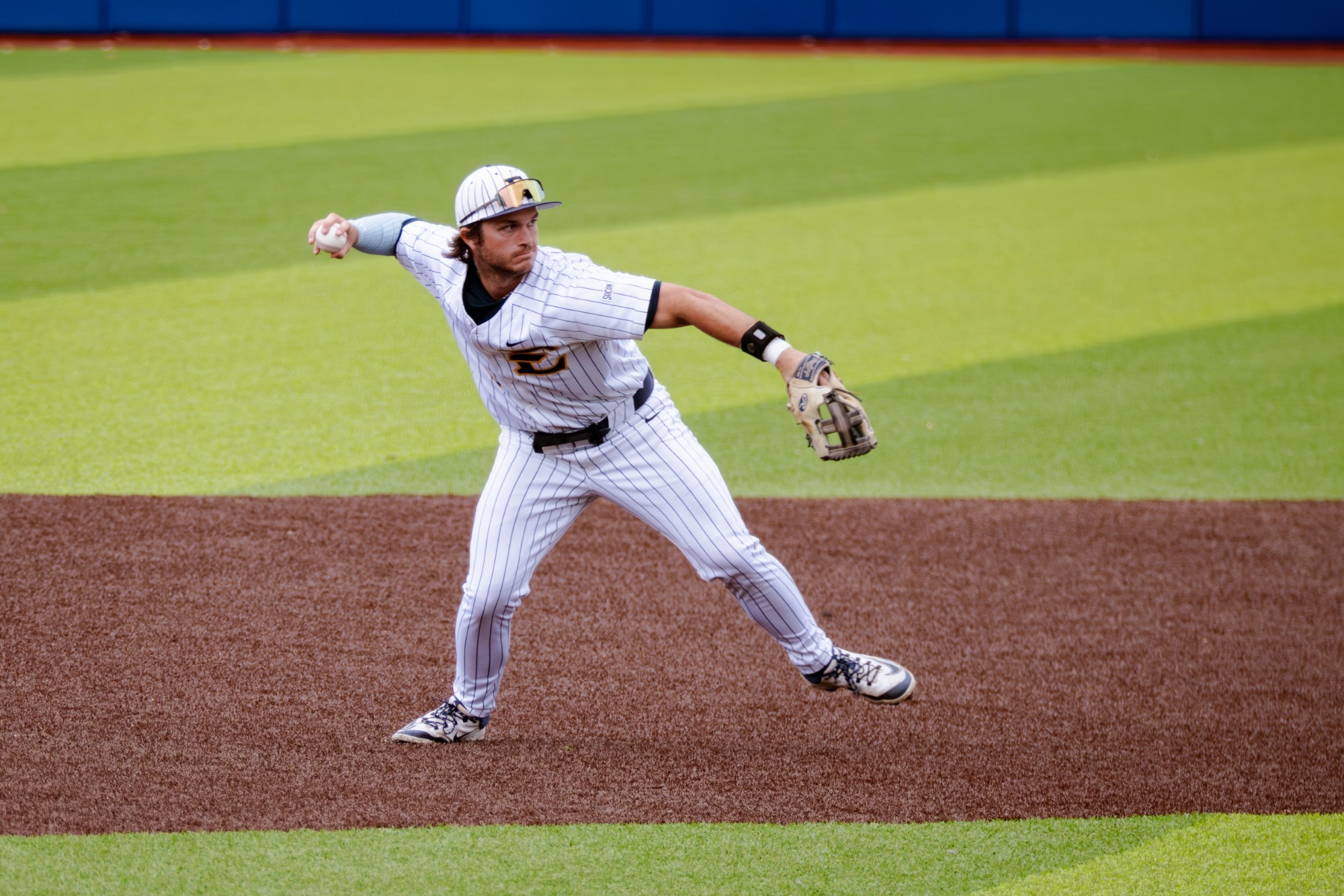 Luke Matlock throws a ball to first base in a game against VMI
