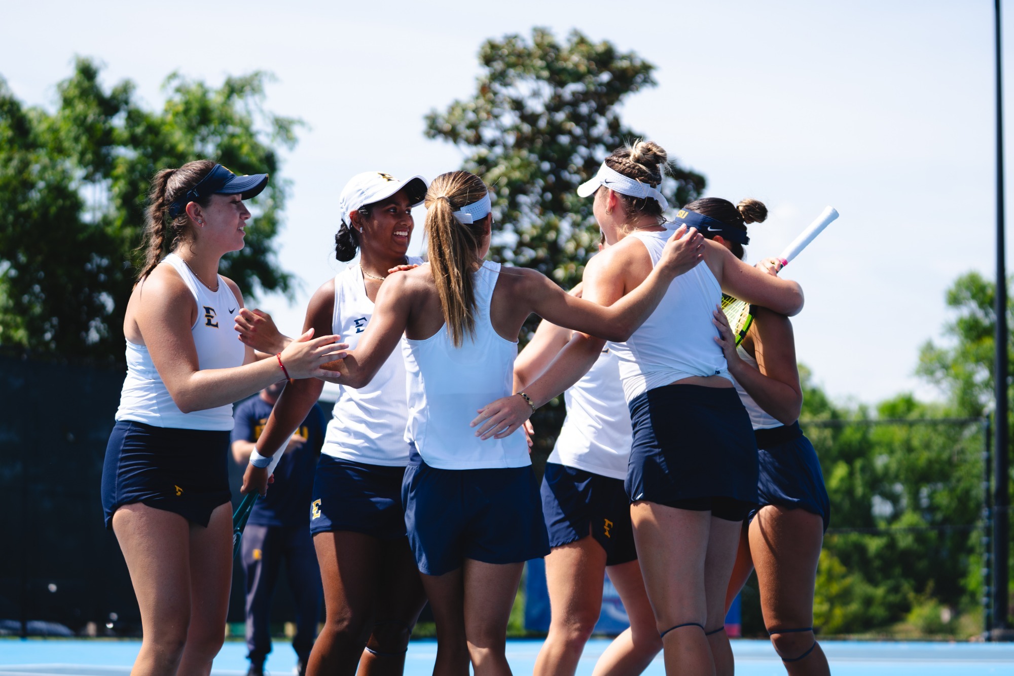 The ETSU women's tennis team celebrates after winning the 2026 SoCon Women's Tennis Tournament