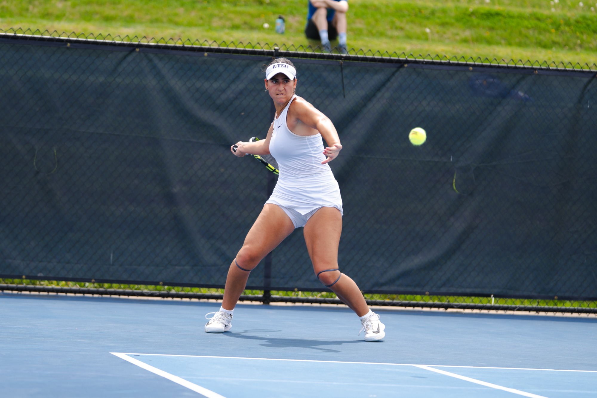 Julia Millian swings a racquet against Samford