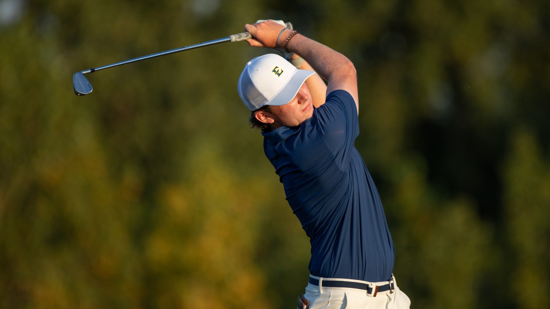 Sophomore men's golfer Gavin Tiernan finishing a swing at the Highlands Invitational in the fall of 2025