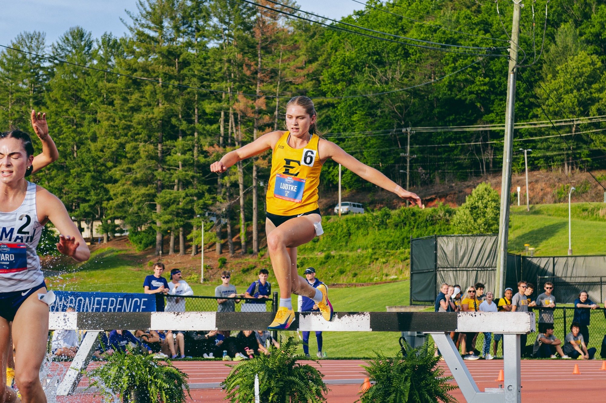 Deena Ludtke leaps over an obstacle during the 3000 meter steeplechase.