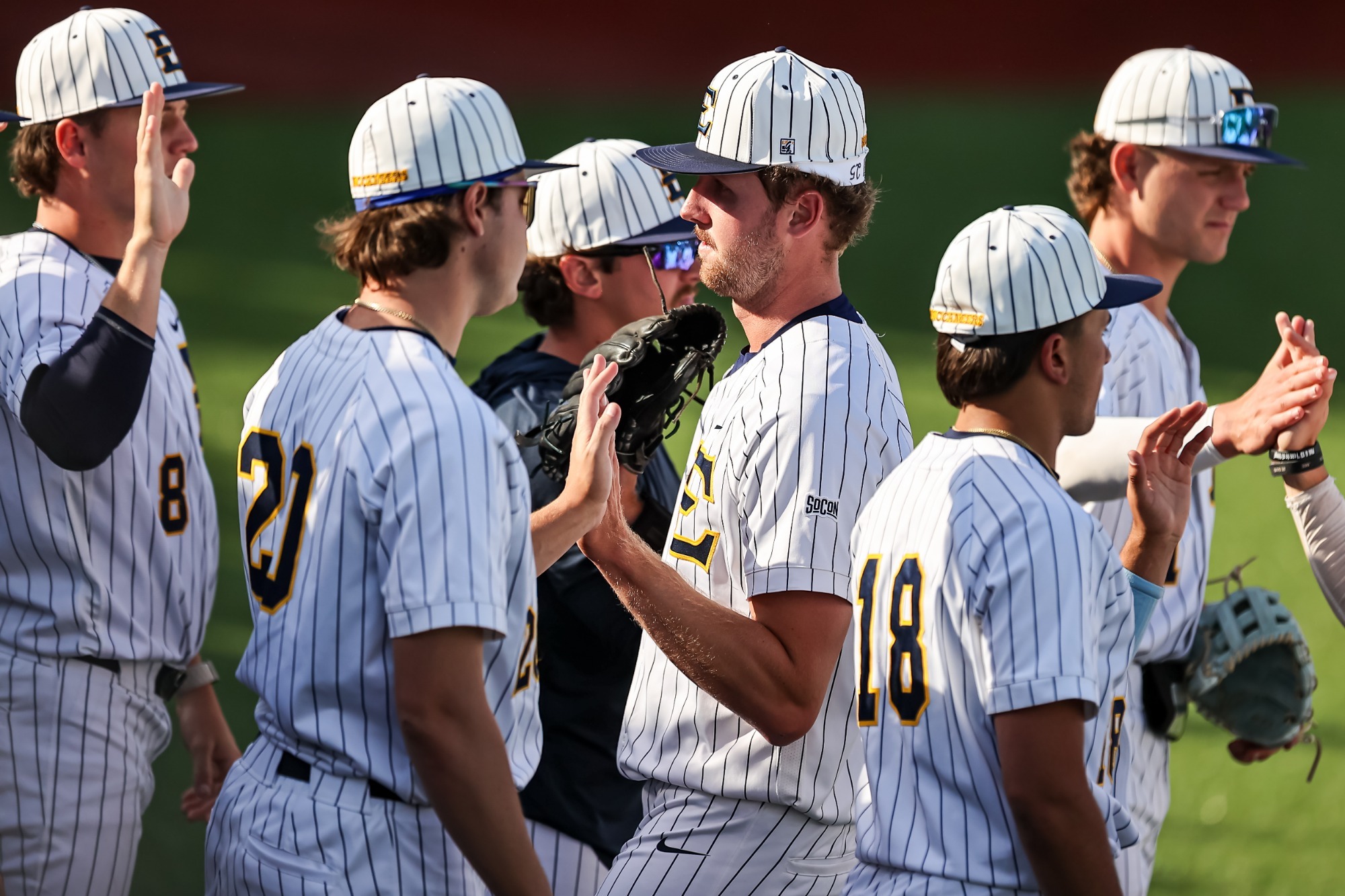 Cody Carwile gets greeted by fellow Bucs after throwing a scorless inning against Radford