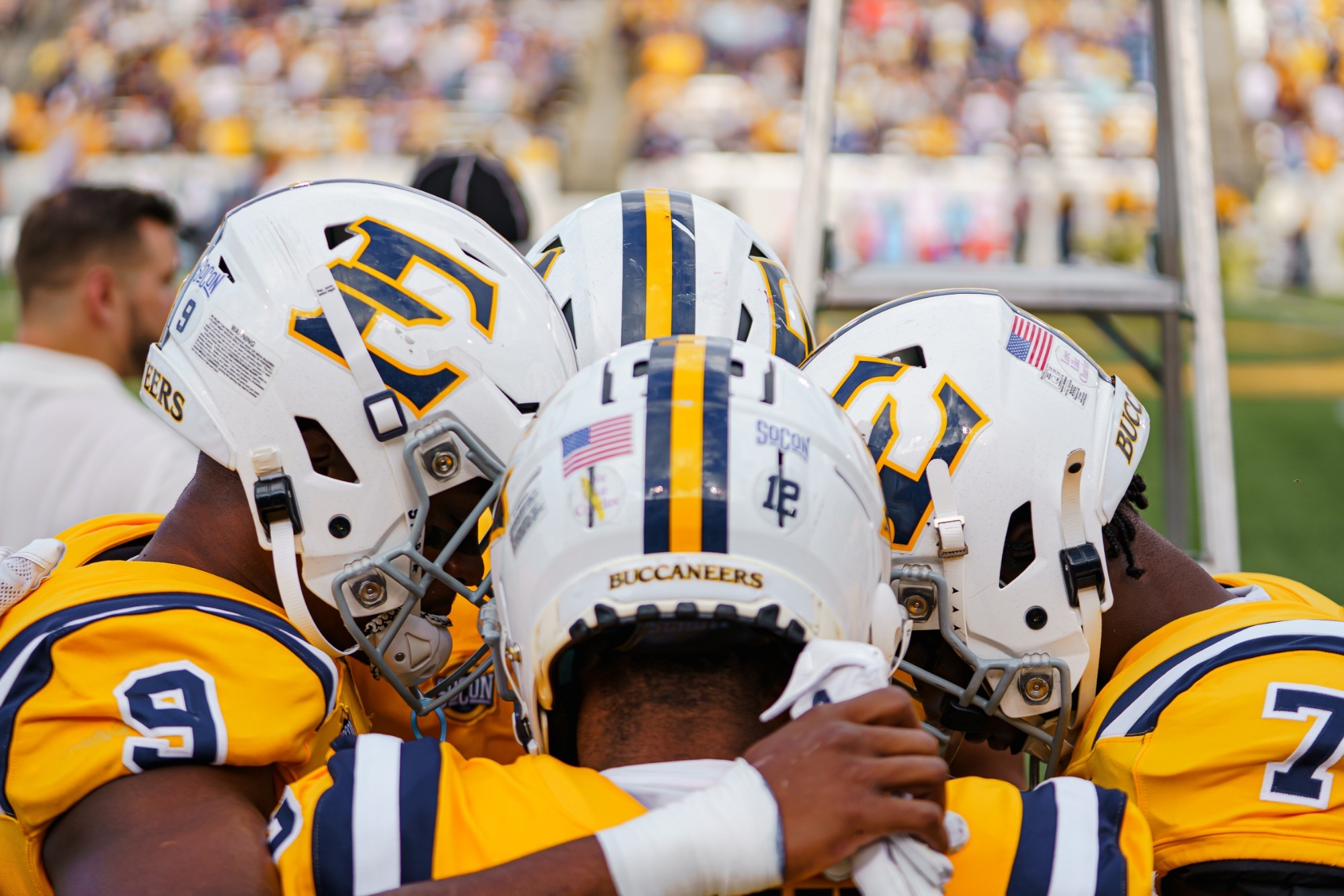 ETSU Football captains huddle before the Bucs' game against Mercer