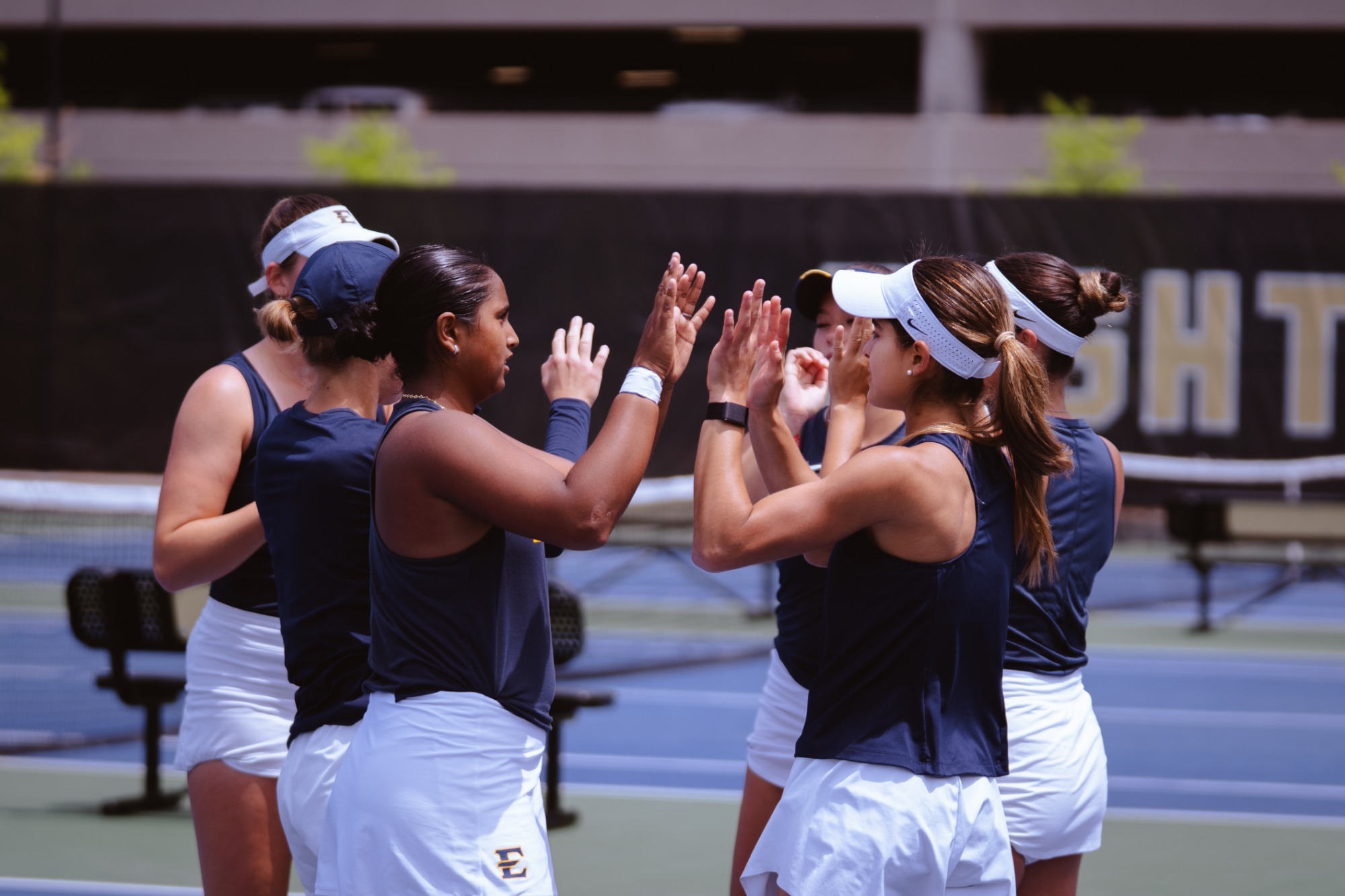 The ETSU women's tennis team huddles before its NCAA Tournament match against Clemson