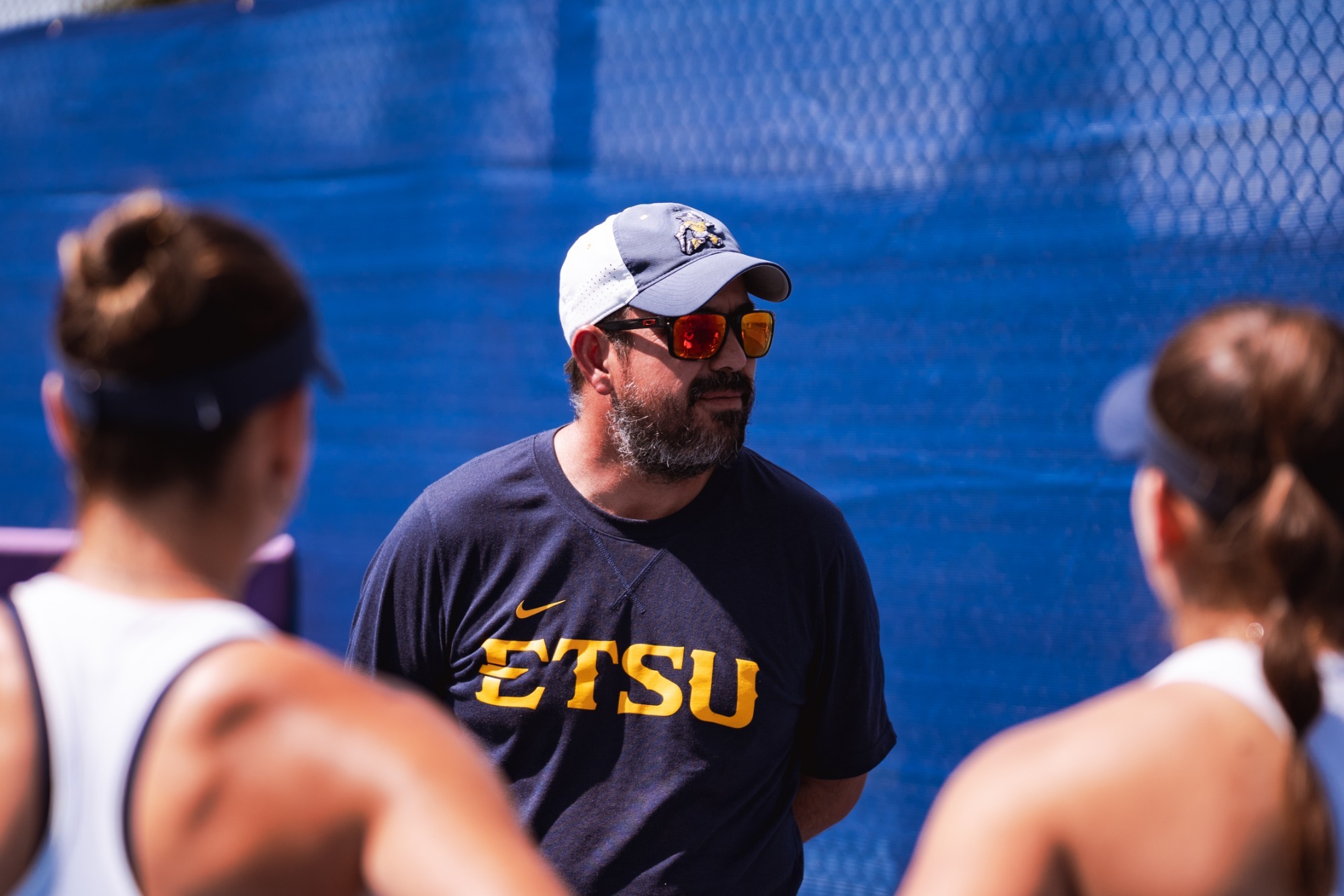 ETSU Director of Tennis Ricky Rojas speaks to his team before a match against Appalachian State