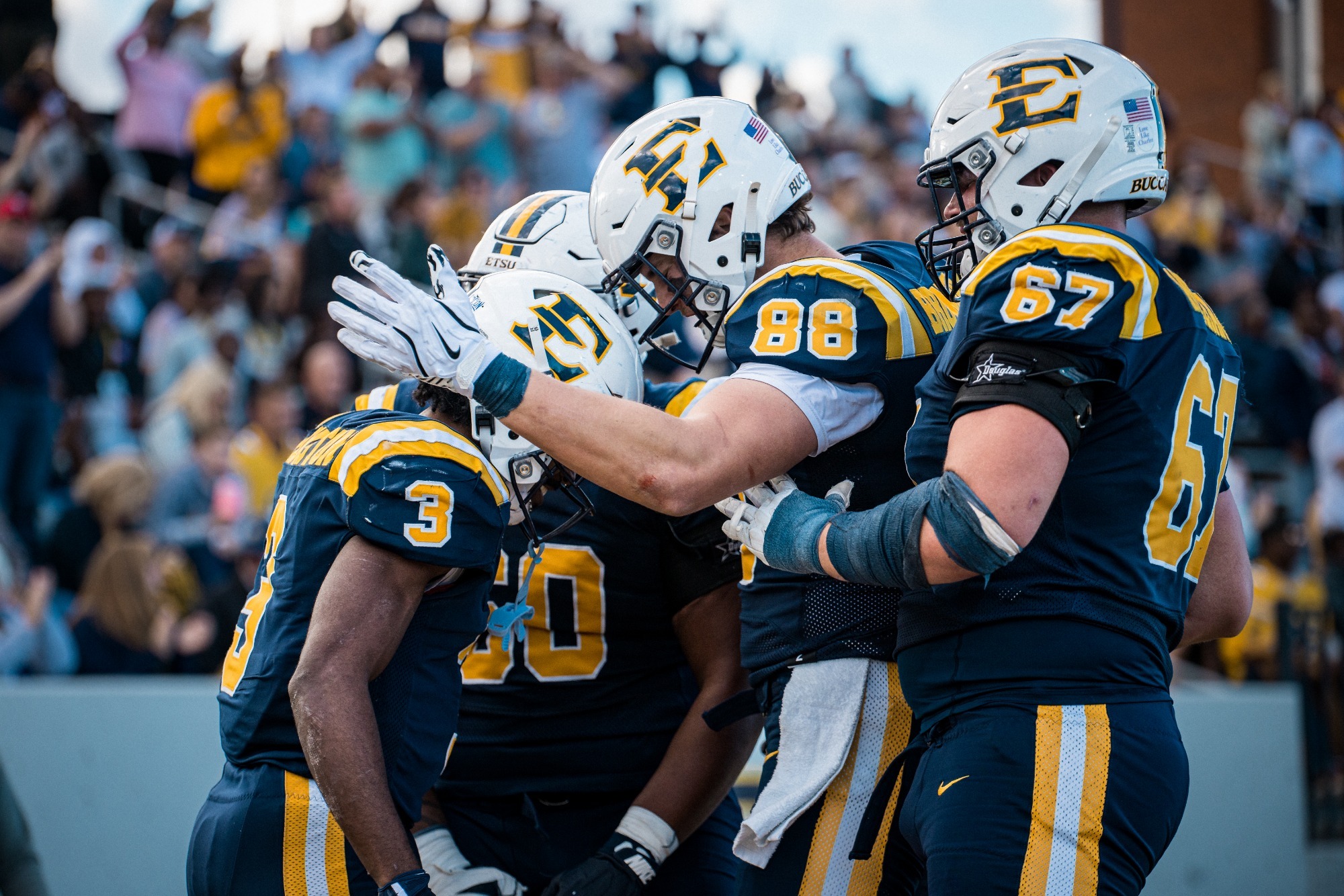The Bucs celebrate a big play against The Citadel during the 2025 season. 
