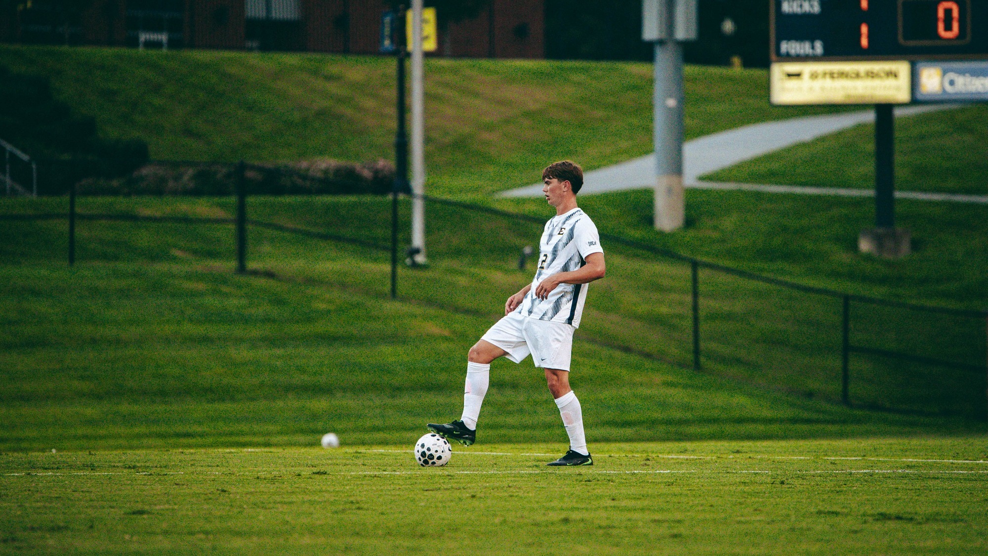 Frank Manrod stands with his right foot over the ball during a soccer game against Emory & Henry.