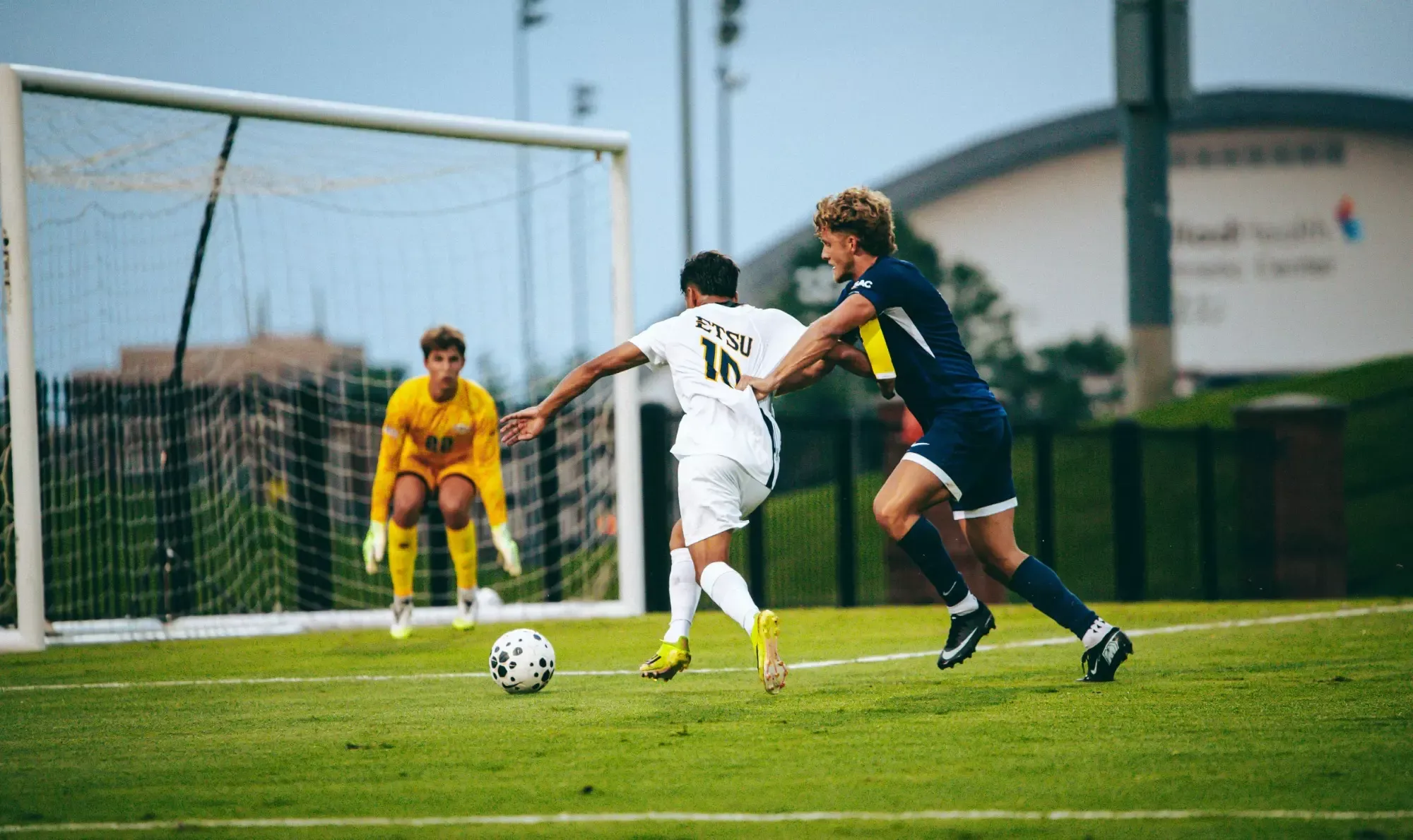 Jaime Carrillo cuts in toward goal from the left side of the 18-yard box while a defender tries to slow him down during a soccer match against Emory & Henry.