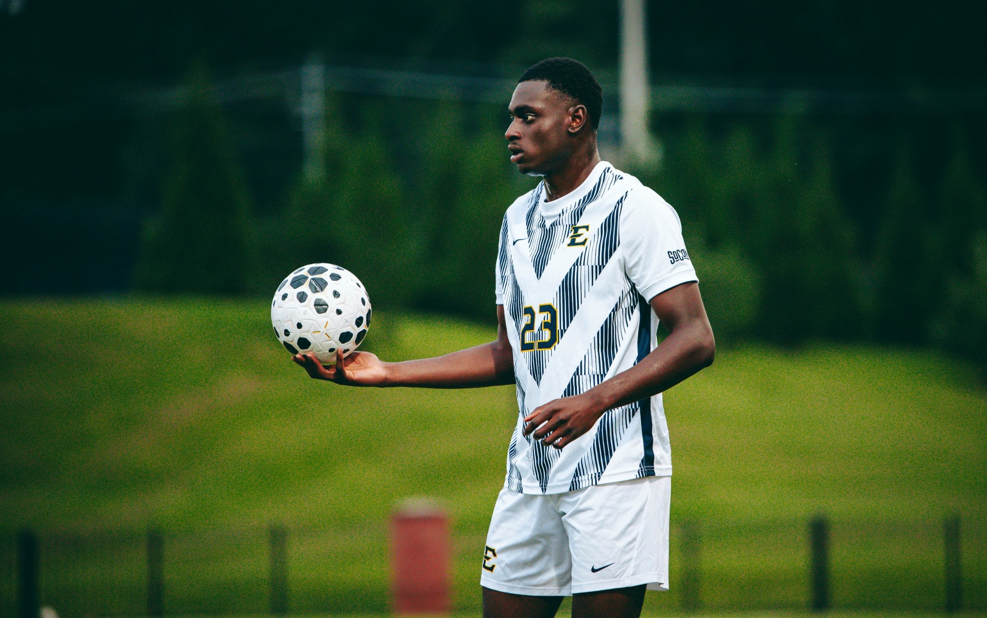 George Chunuwe waits to take a throw-in with the ball in his right hand during a soccer match against Emory & Henry.
