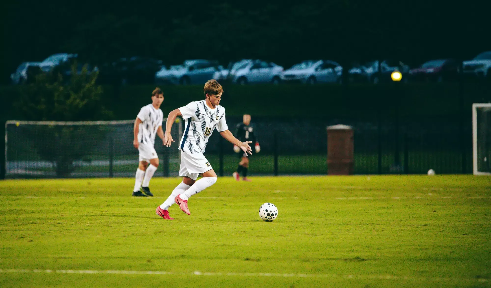 Liam Gummer sprints in pursuit of a soccer ball during a match with Emory & Henry.