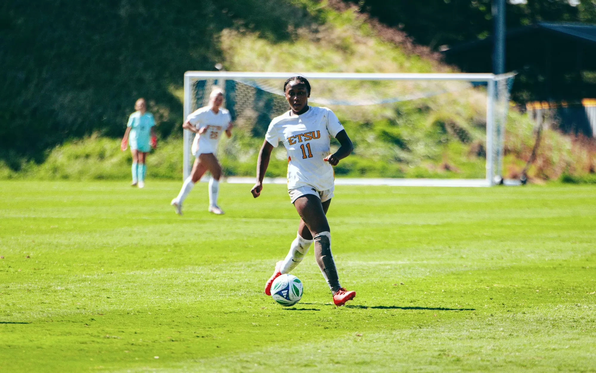 Jada Cooper strafes behind the ball as she dribbles into an attacking area against UNC Asheville.