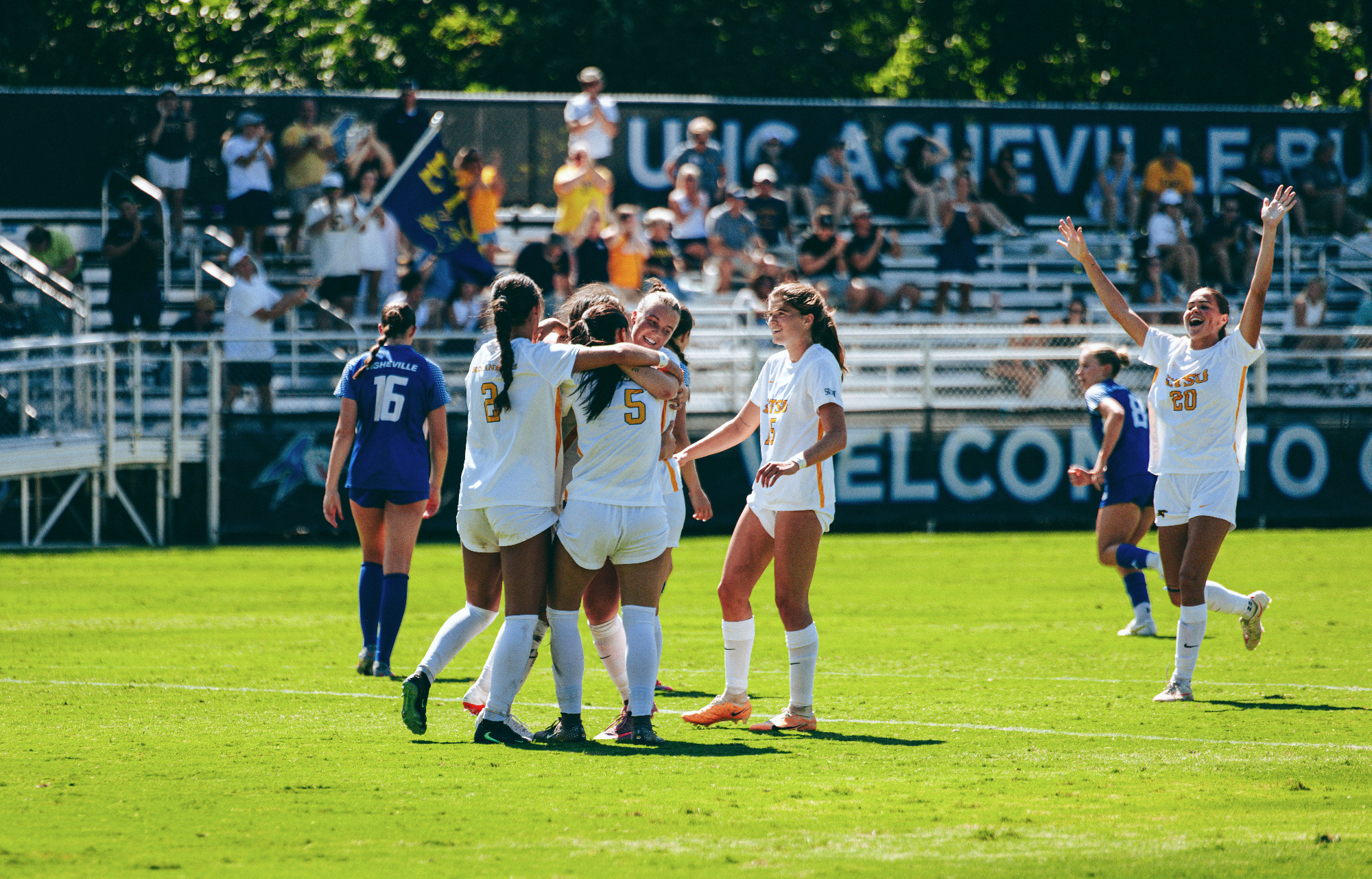 The ETSU women's soccer team celebrates a goal at UNC Asheville.
