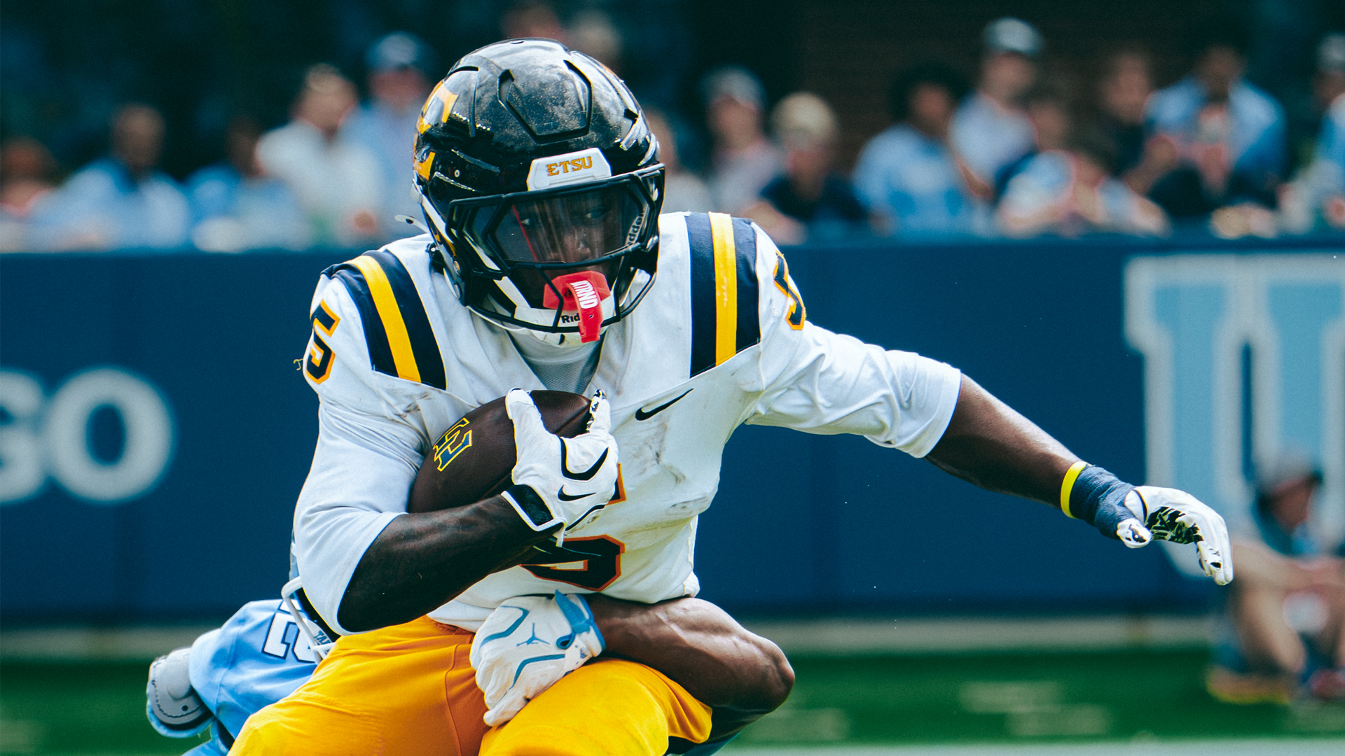 TJ Peyton carries the ball for the Bucs in a game against North Carolina