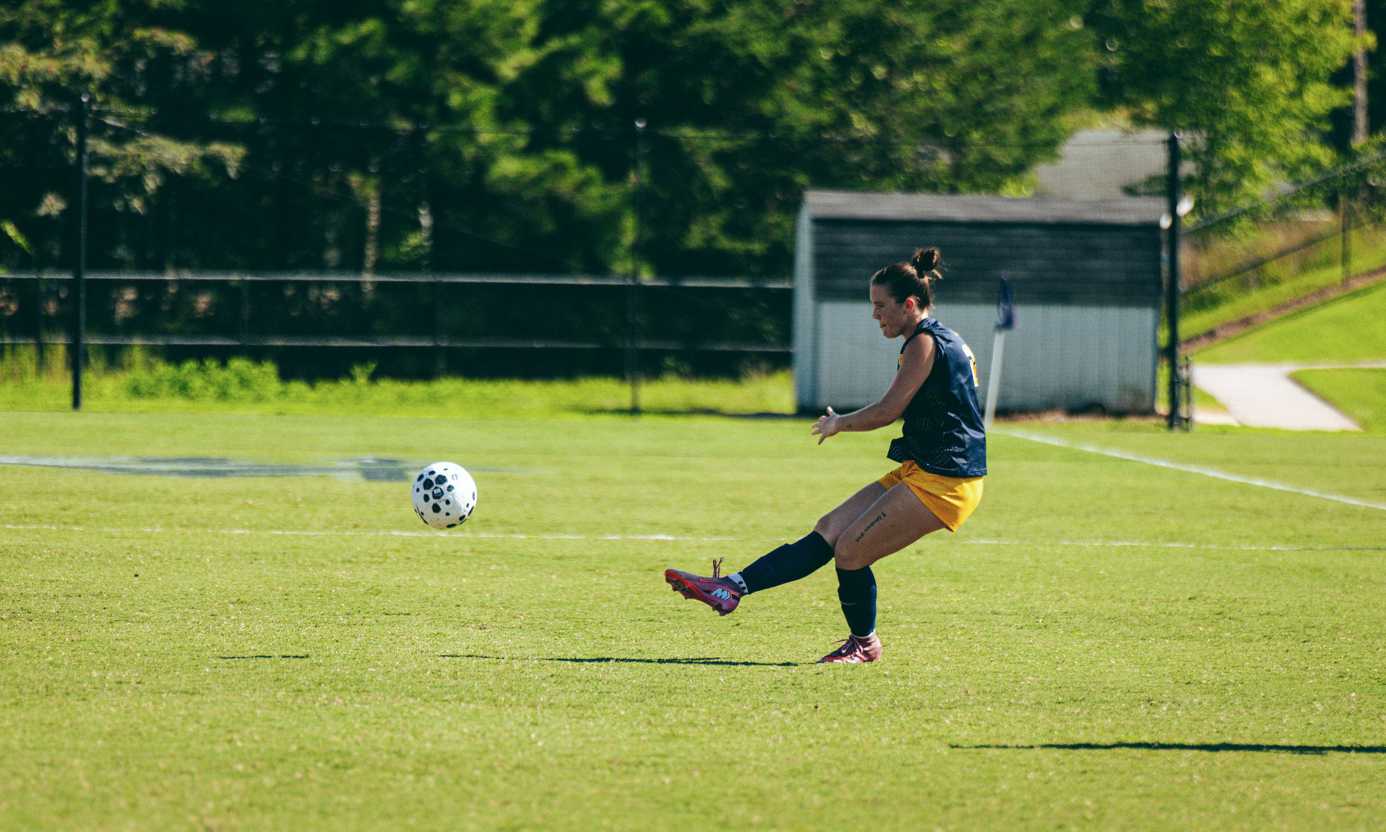 Kassie Estep launches a free kick with her right foot in a soccer game at Longwood.