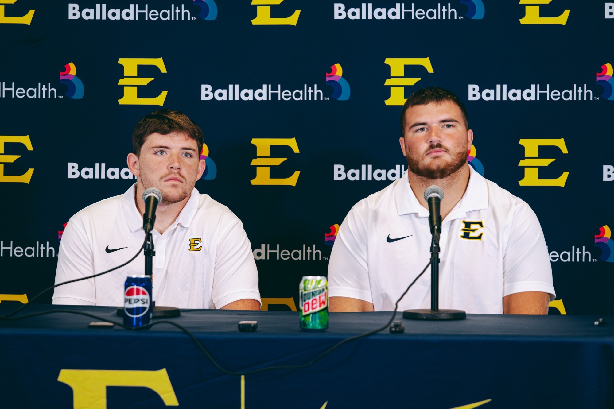 Jason Albritton and Brenden LeBlanc listen to questions posed by media members at a press conference