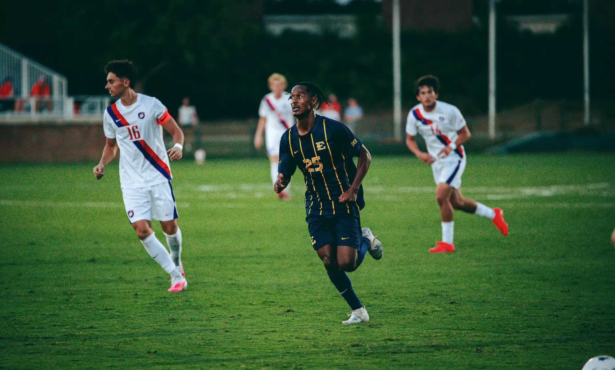 Shewit Worton runs up the left wing in support of an unseen attacking player with the ball during a soccer match at Clemson.