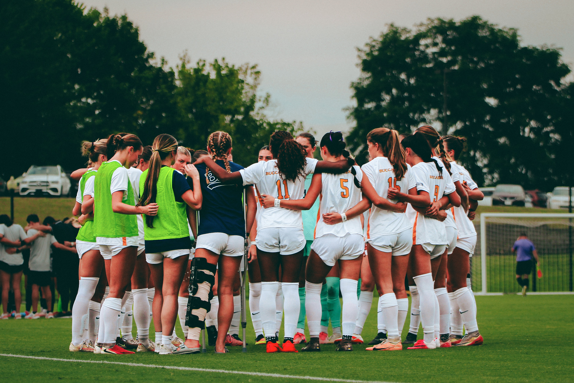 The ETSU women's soccer team huddles up before an evening match against Mercer.