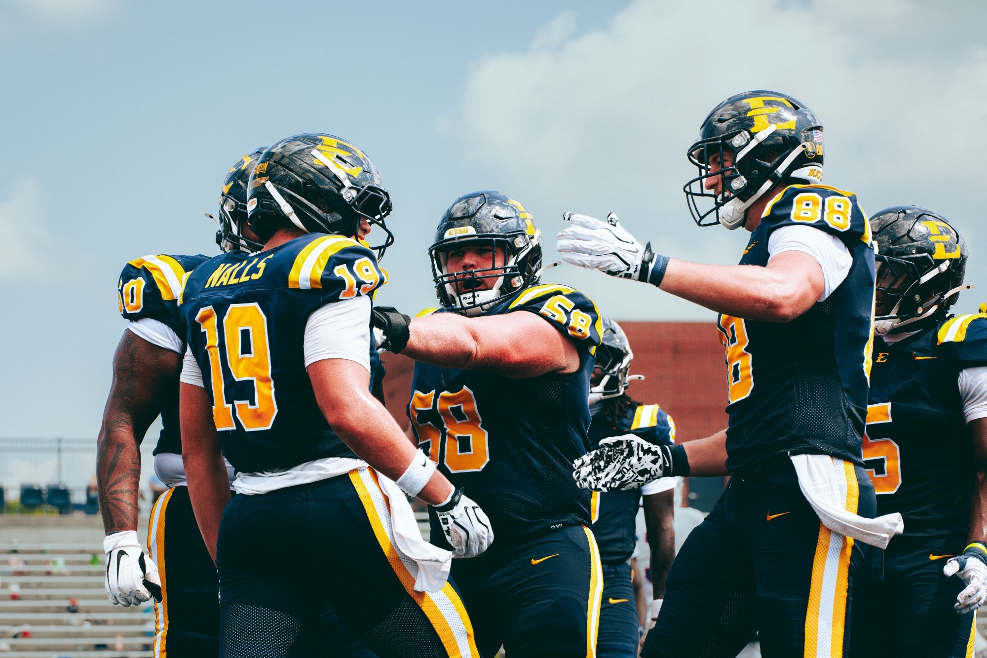 The Buccaneer football team celebrates after a touchdown scored against West Georgia