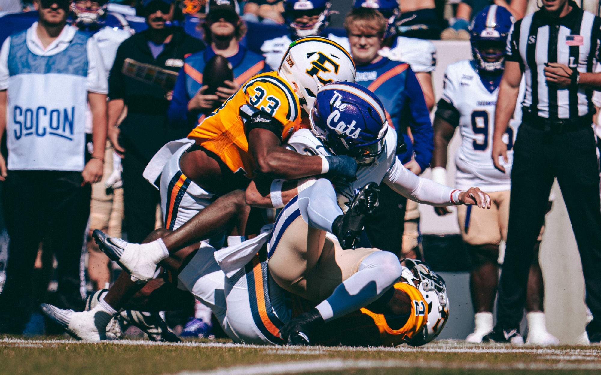 ETSU football team grouped up to tackle a ball carrier in a win vs. Western Carolina