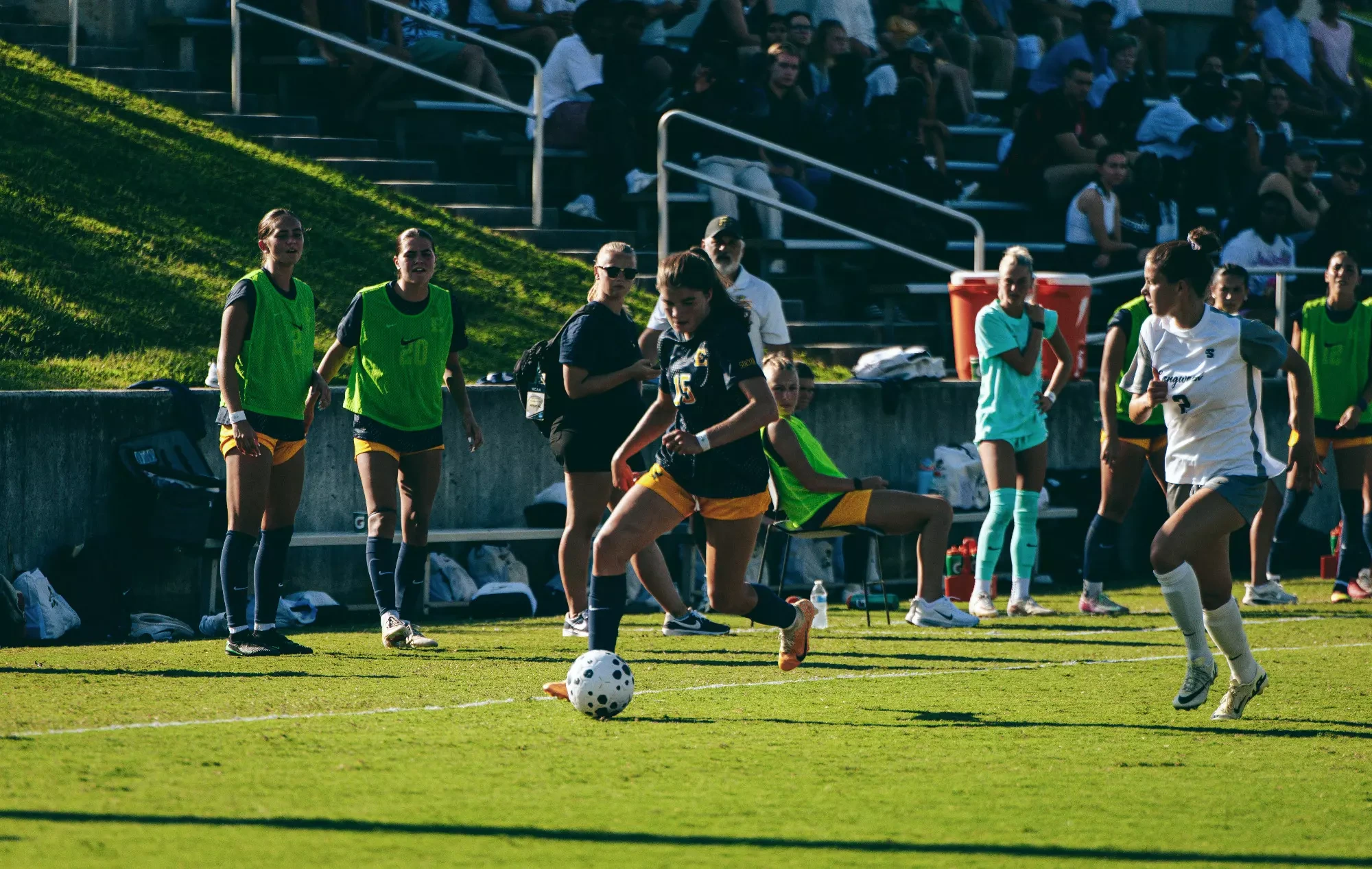 Ava Duffey dribbles past a defender down the right wing during a soccer match at Longwood.