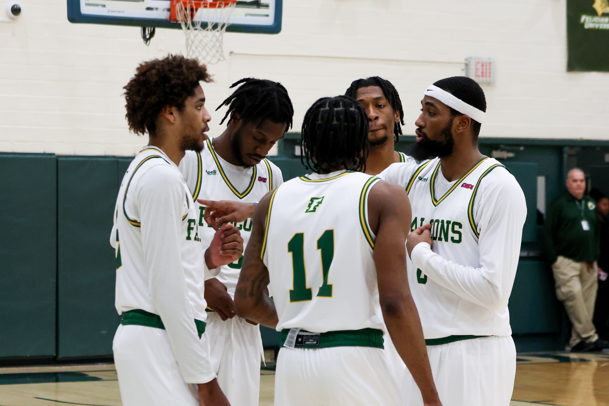 Felician men’s basketball huddles on the court.