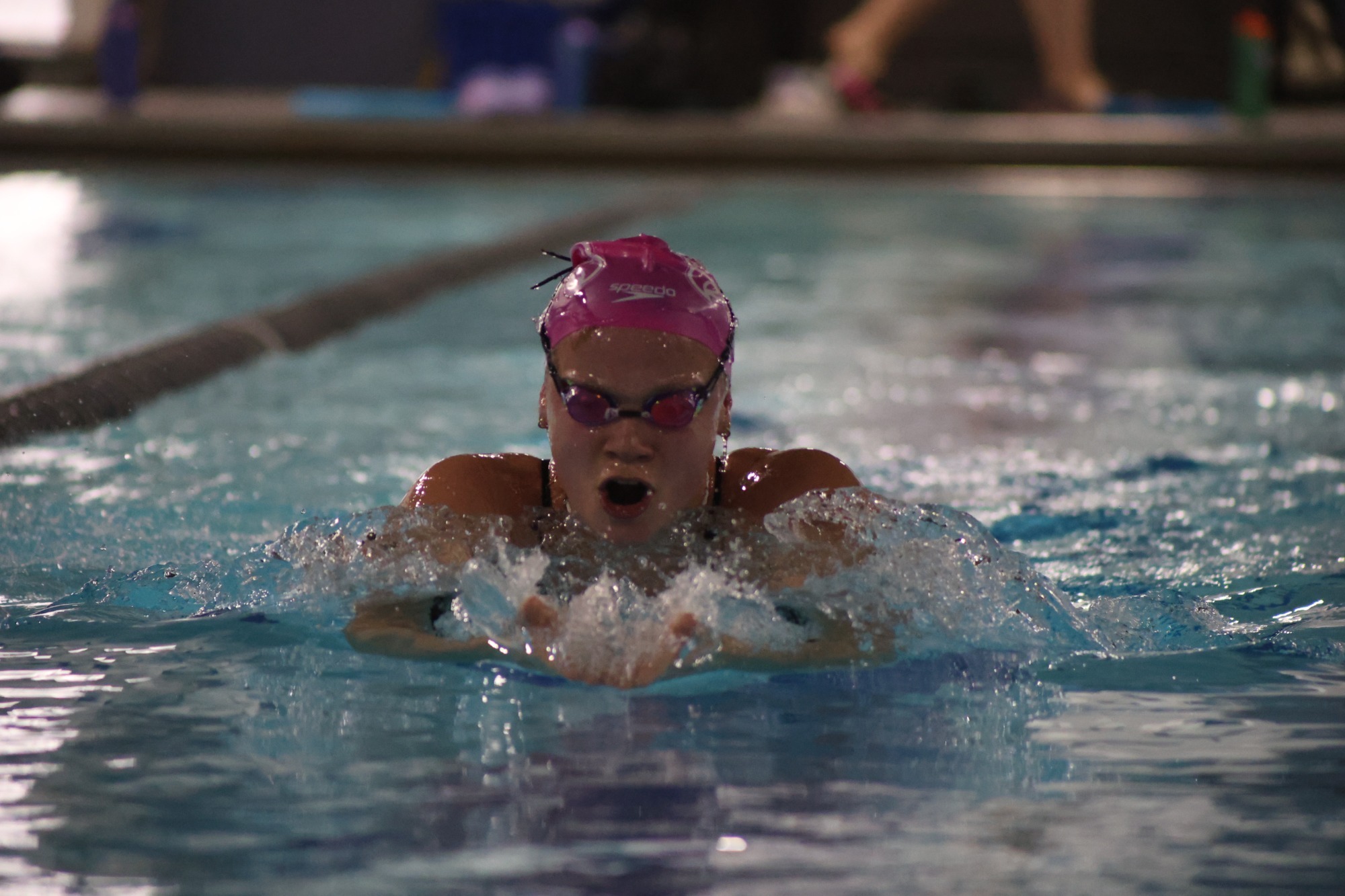 Elena Kaufman breaches the water mid lap during a breaststroke