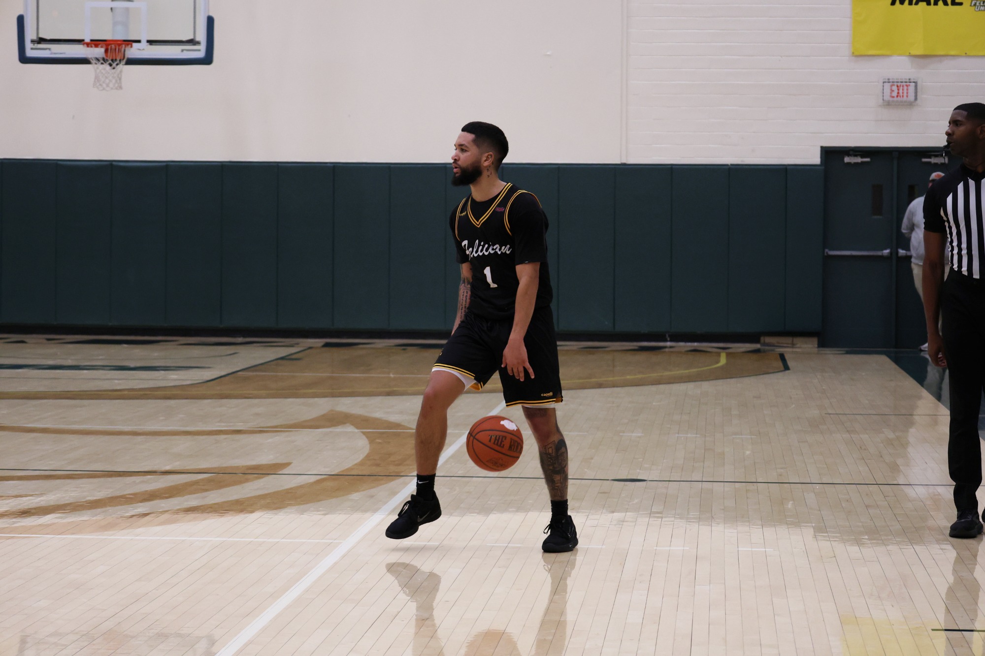 Noah Hutchins dribbles the basketball.