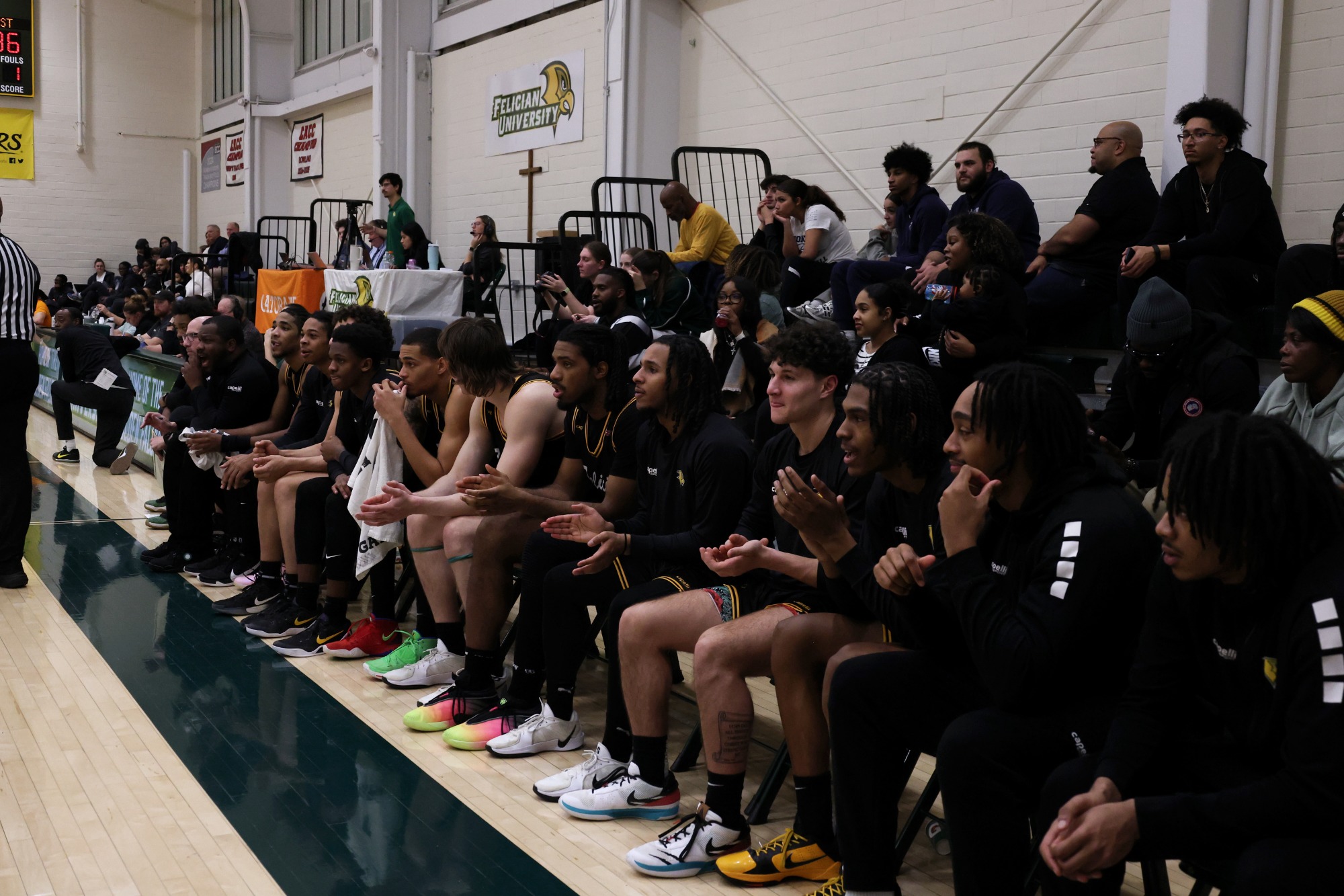 Team bench clapping on the sidelines.